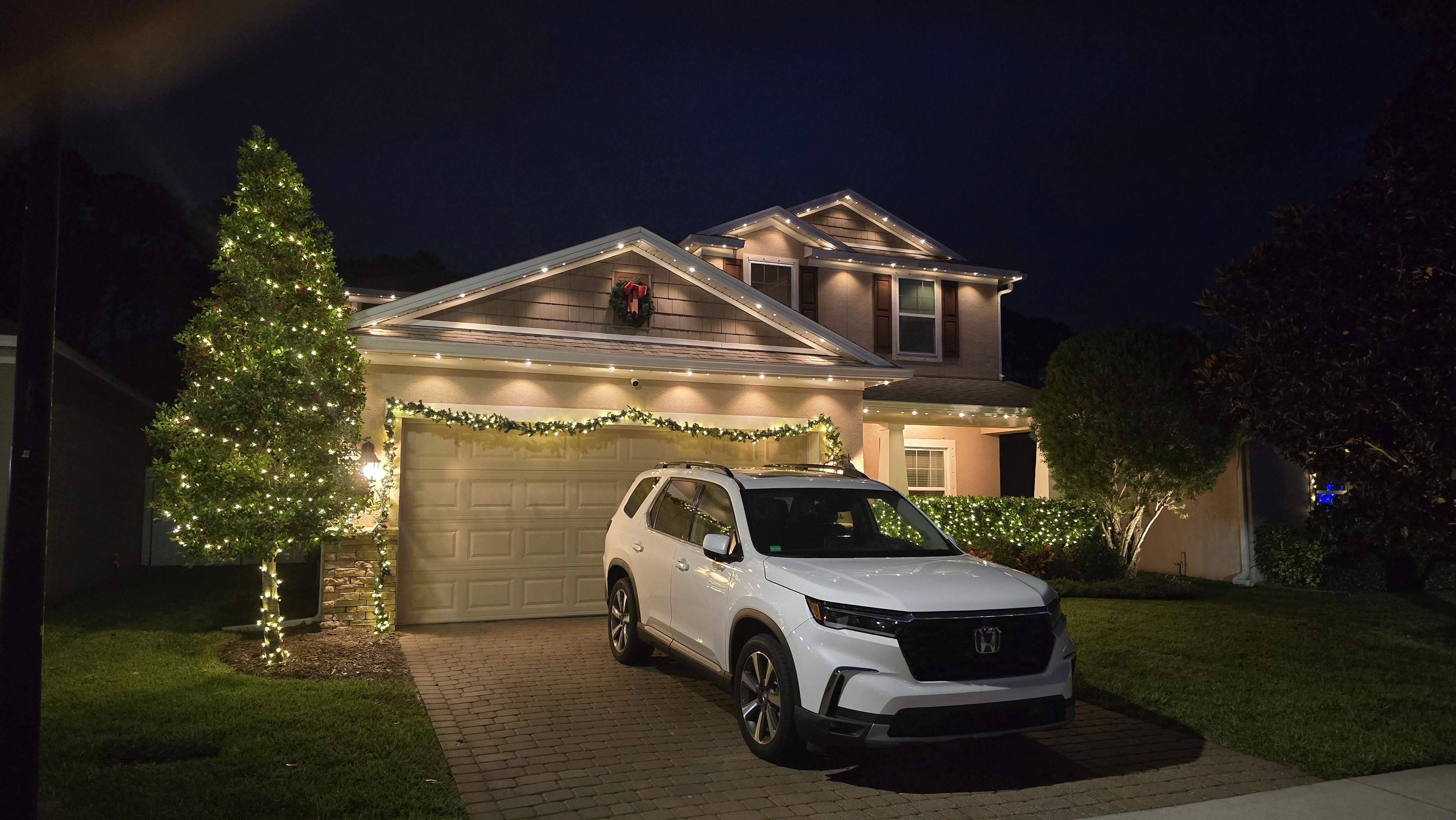 Warm white permanent LED lighting installed along residential roofline