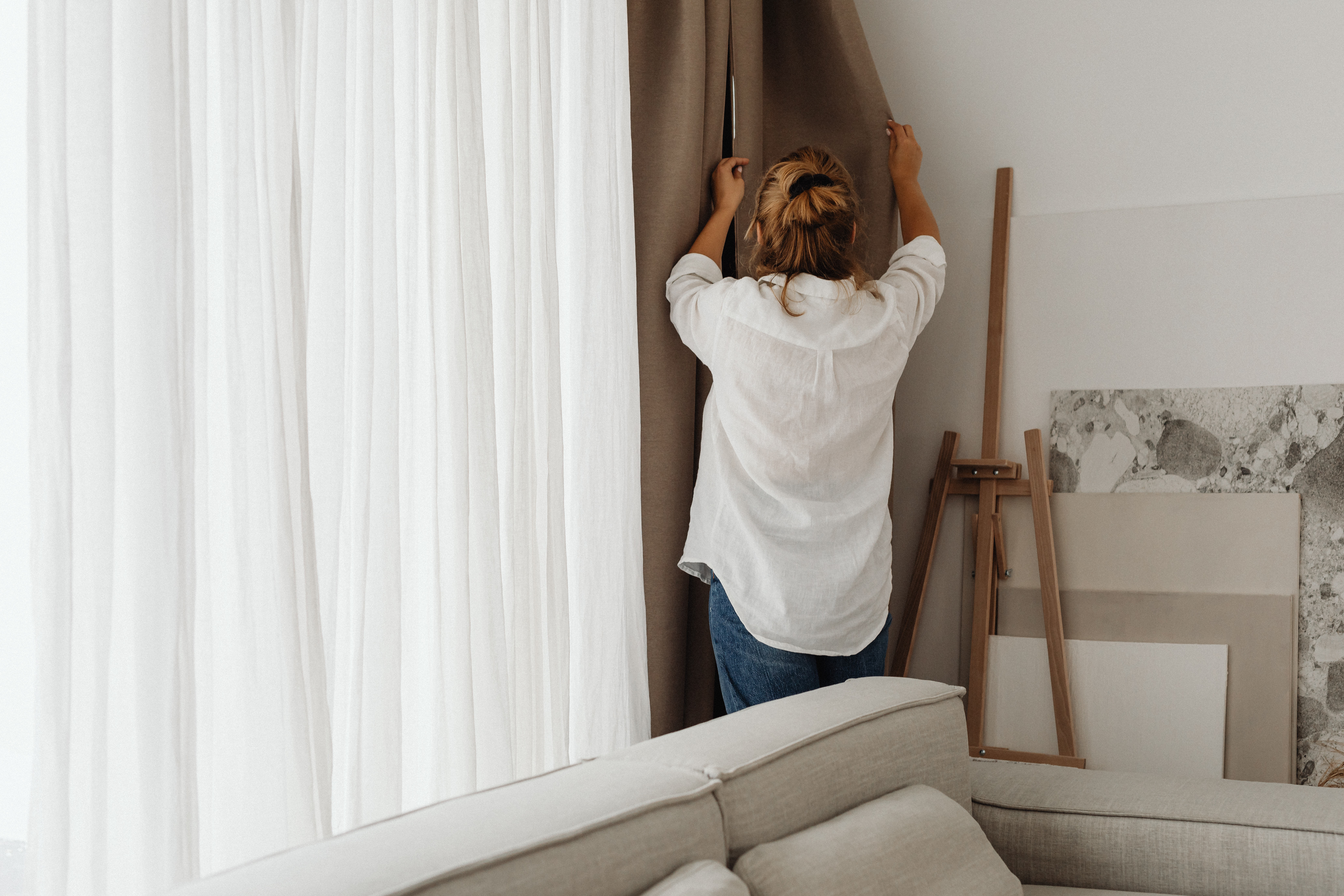 Woman adjusting curtains