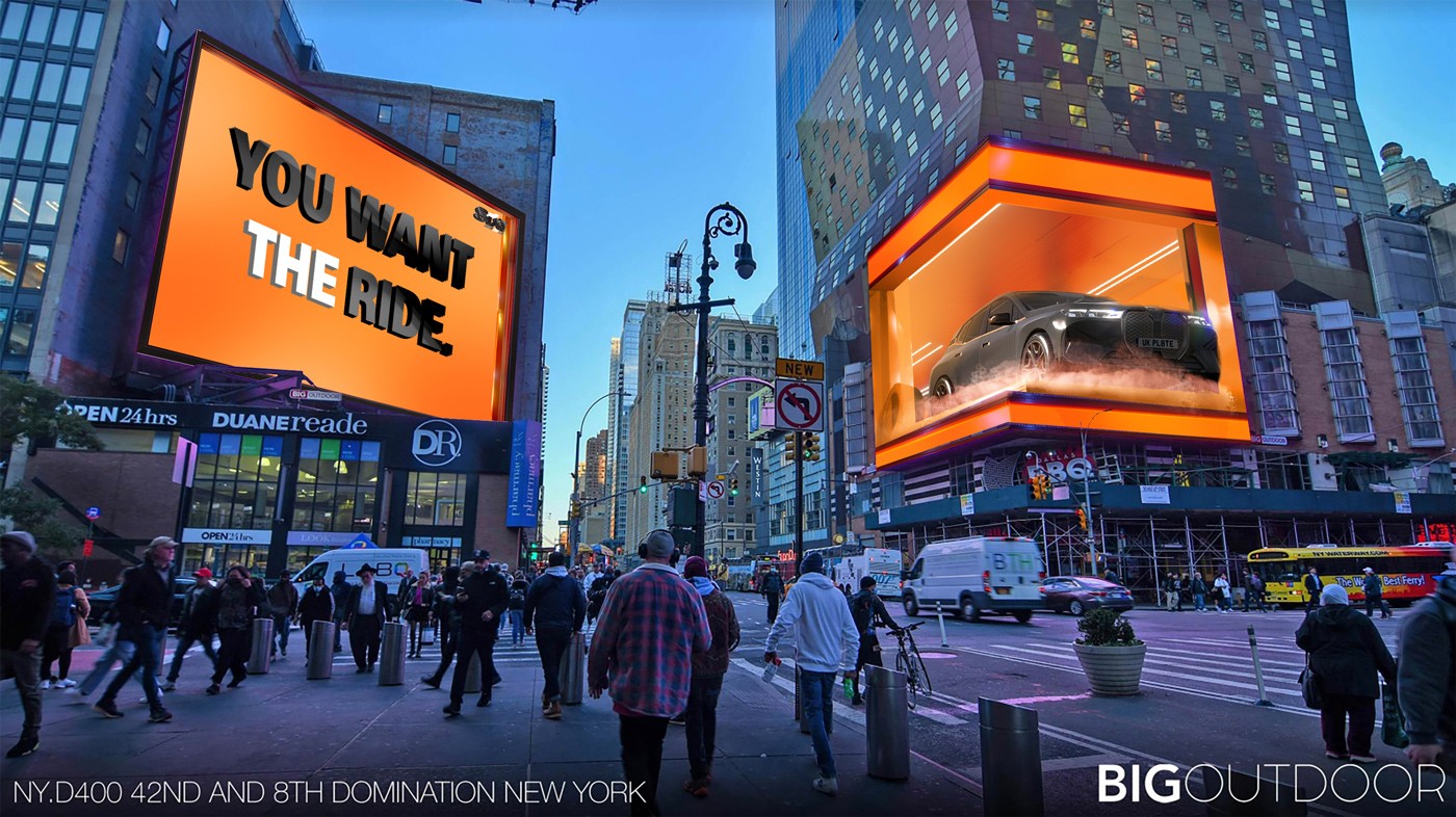 Team collaborating in a modern office with computers and laptops on a shared desk.