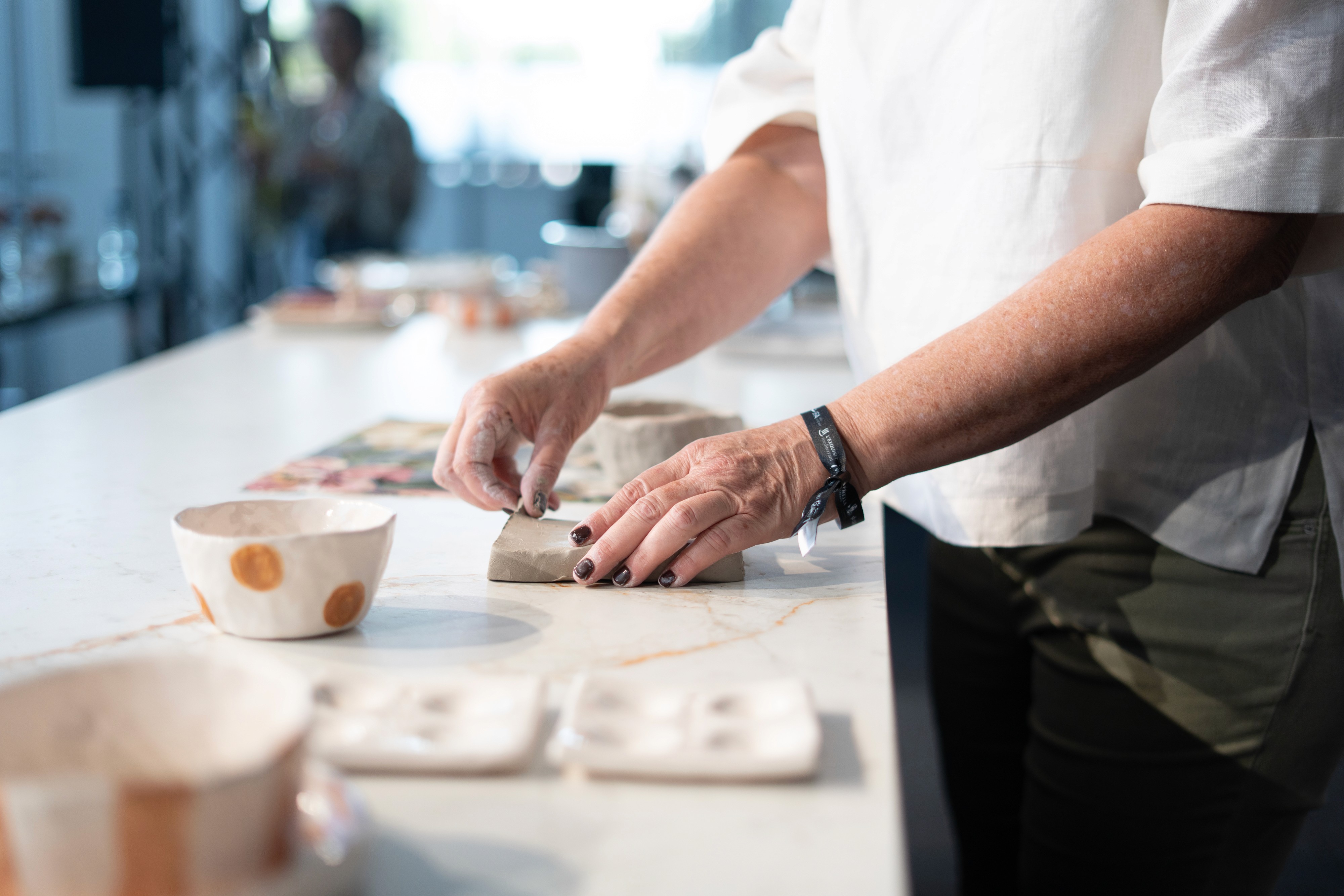 A woman with a head made of mirrors, reflecting light and creating a kaleidoscopic effect around her.