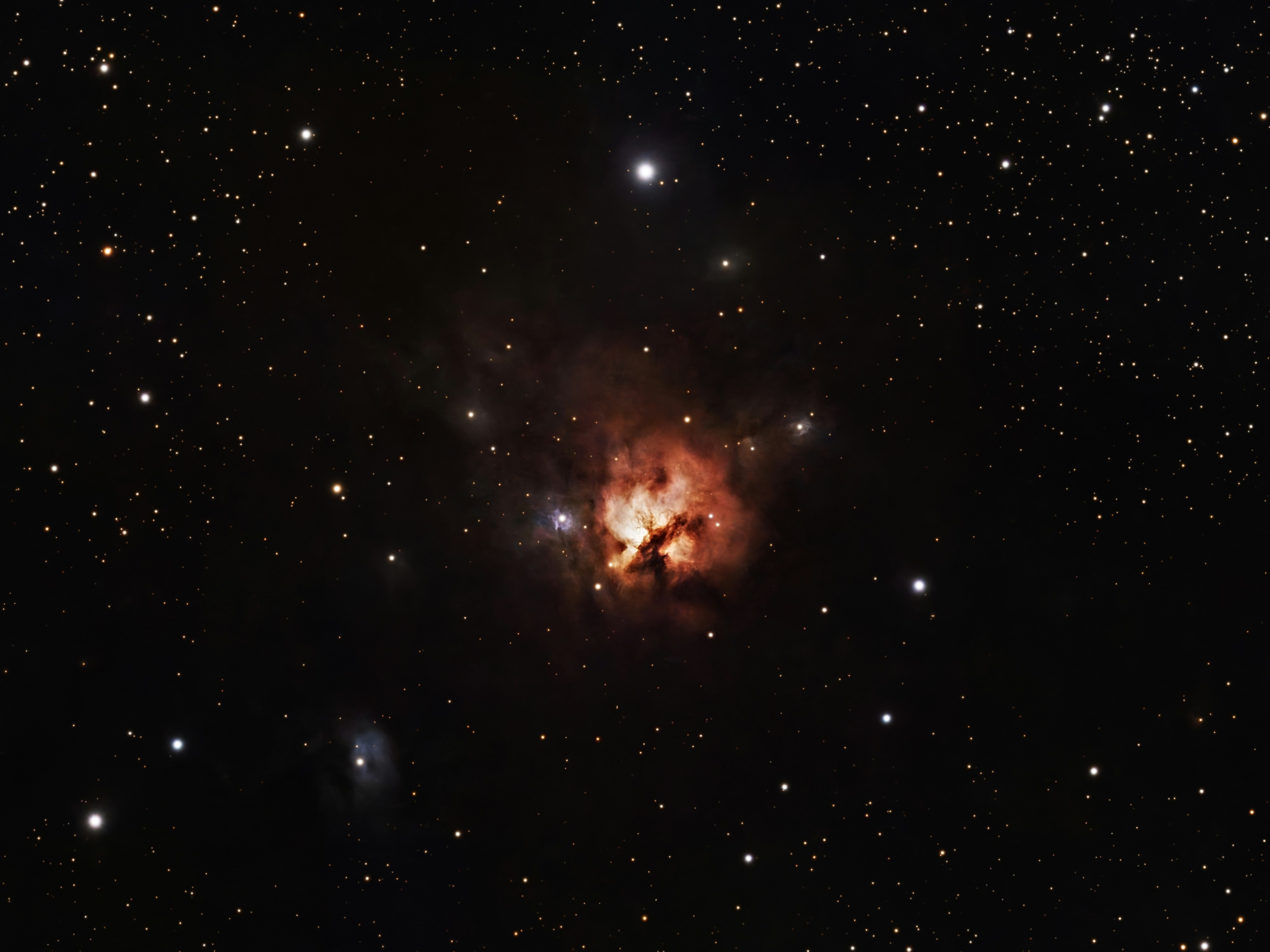 Colorful nebula surrounded by distant stars
