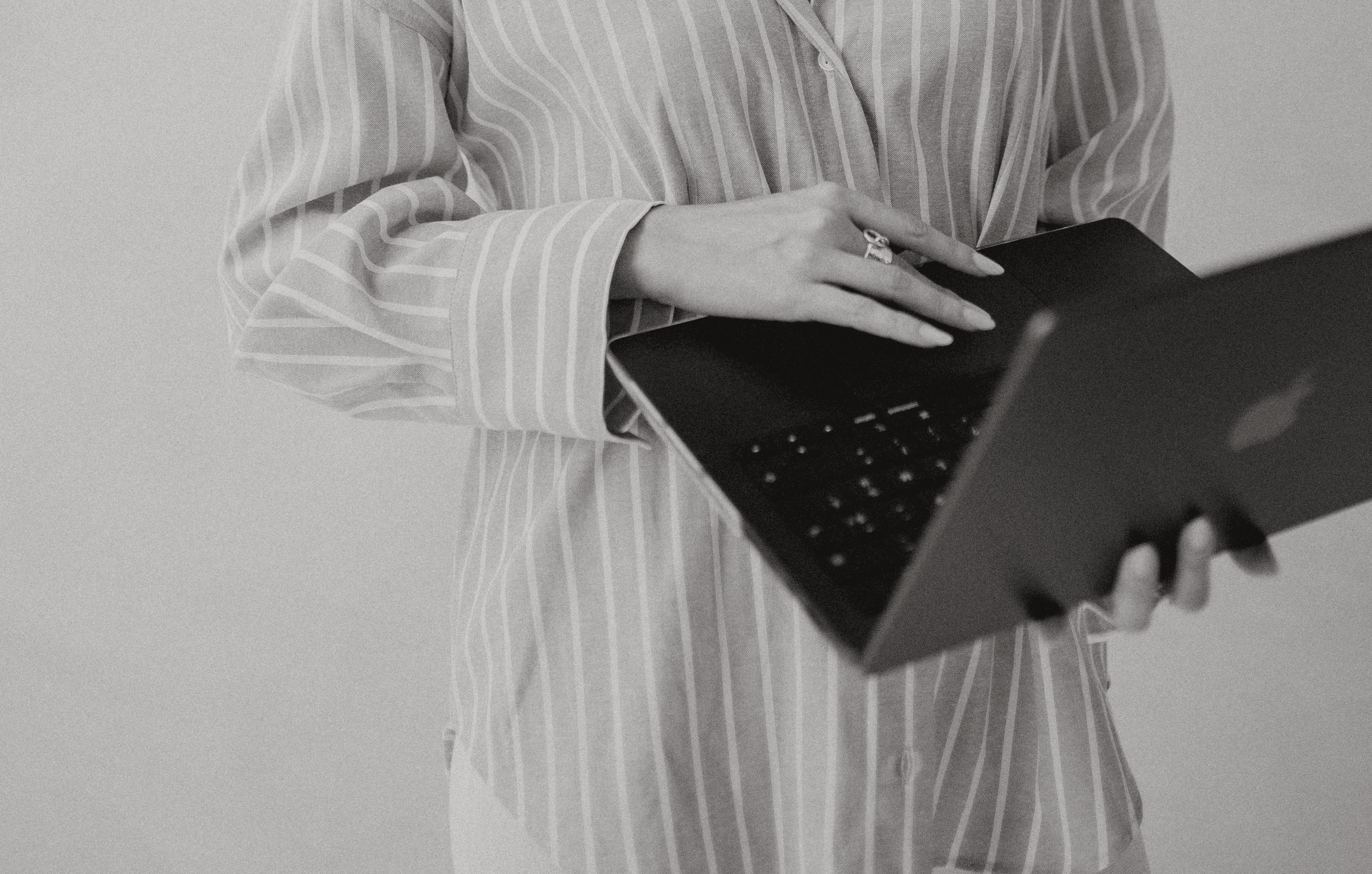 A close-up of a beige-colored laptop with a smooth, matte finish on a matching surface.