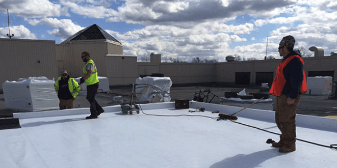 Roofers working on roof