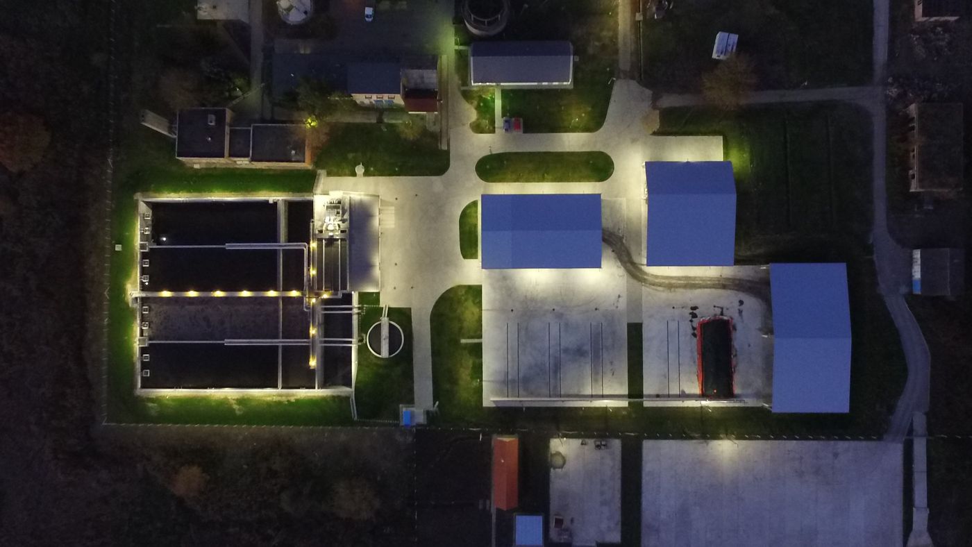 Night-time aerial view of the illuminated Ózd wastewater treatment plant, Hungary