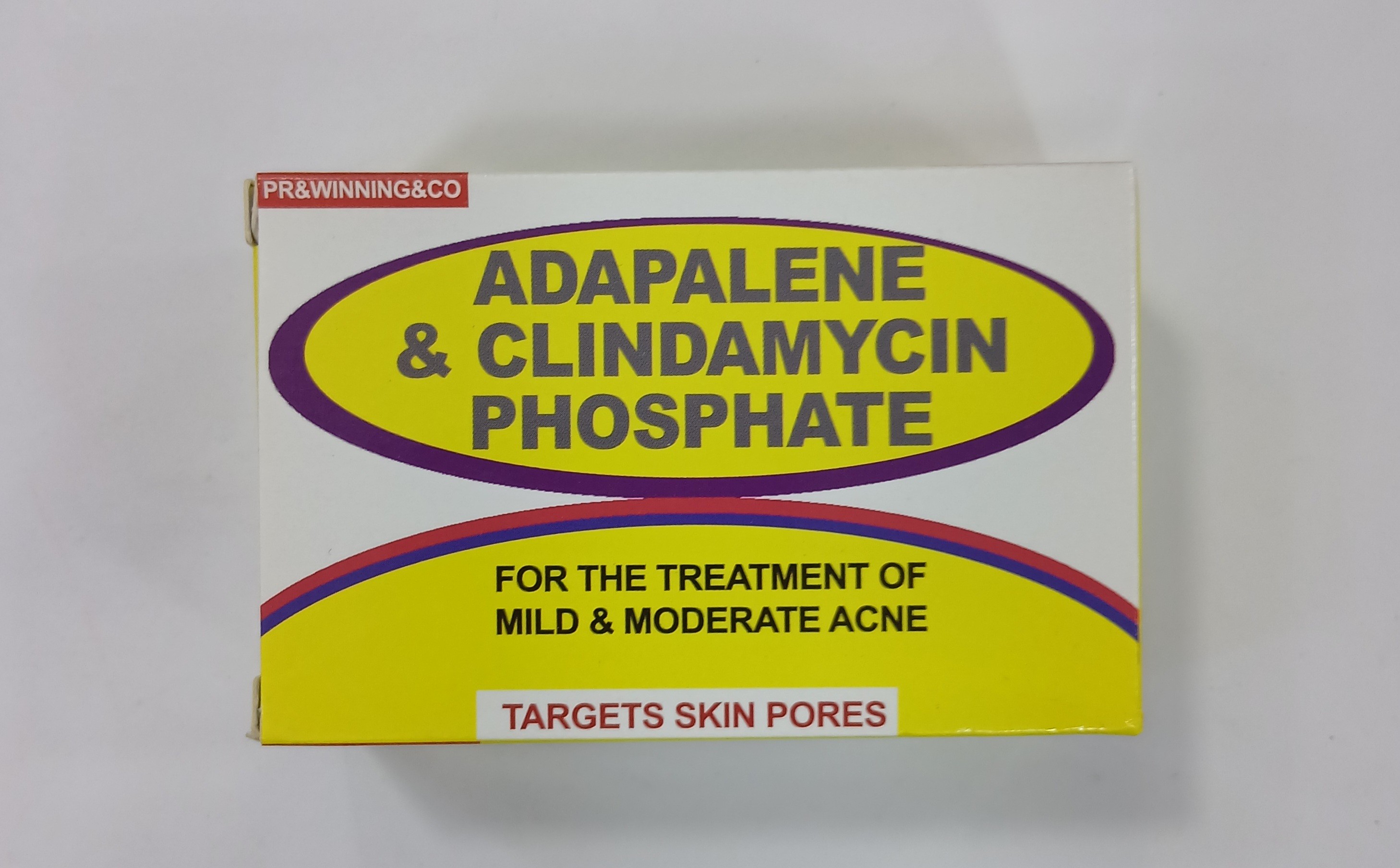 Yellow and purple cardboard packaging displays text indicating it is for treating mild and moderate acne with active ingredients targeting skin pores.
