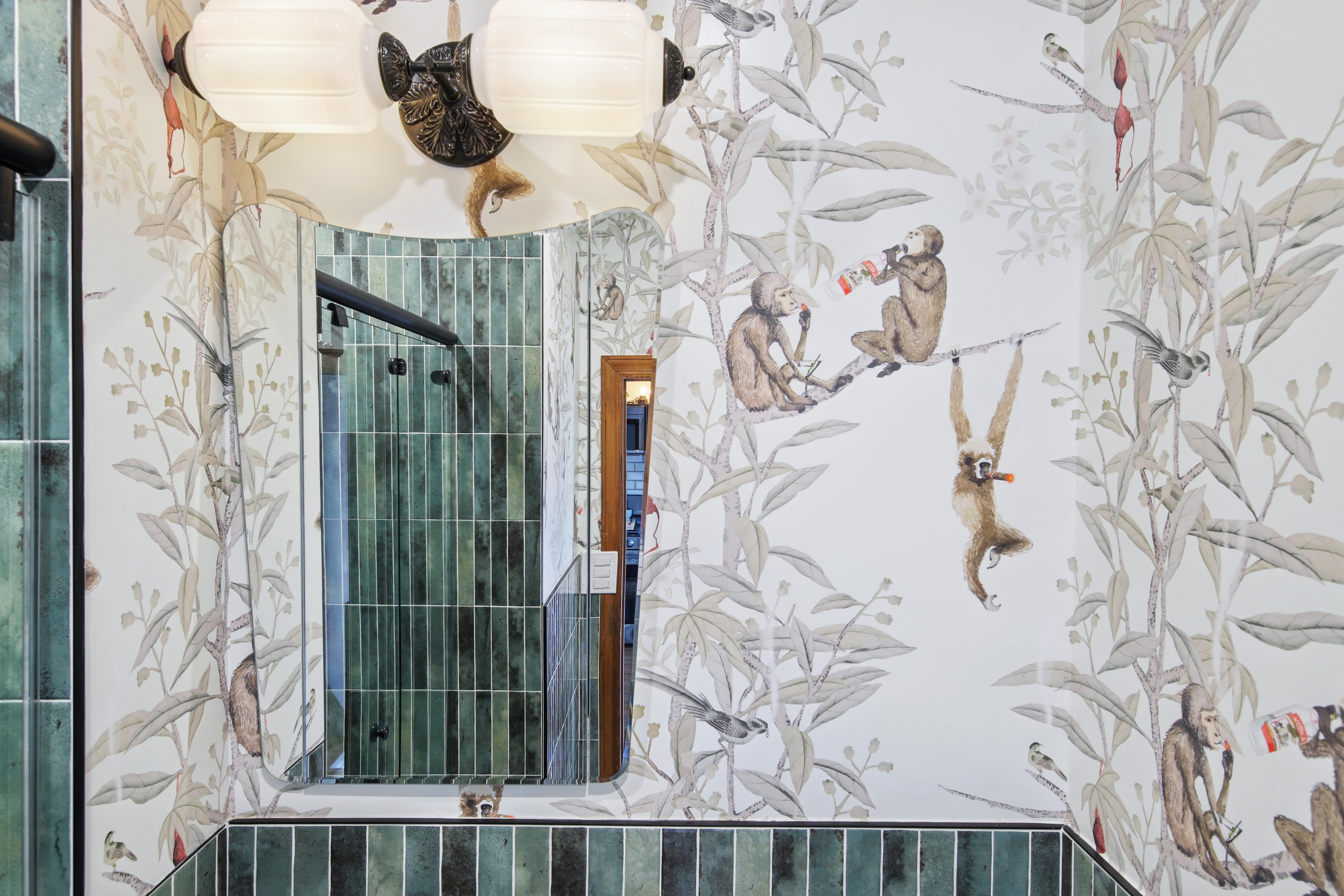 modern bathroom with jungle themed wallpaper