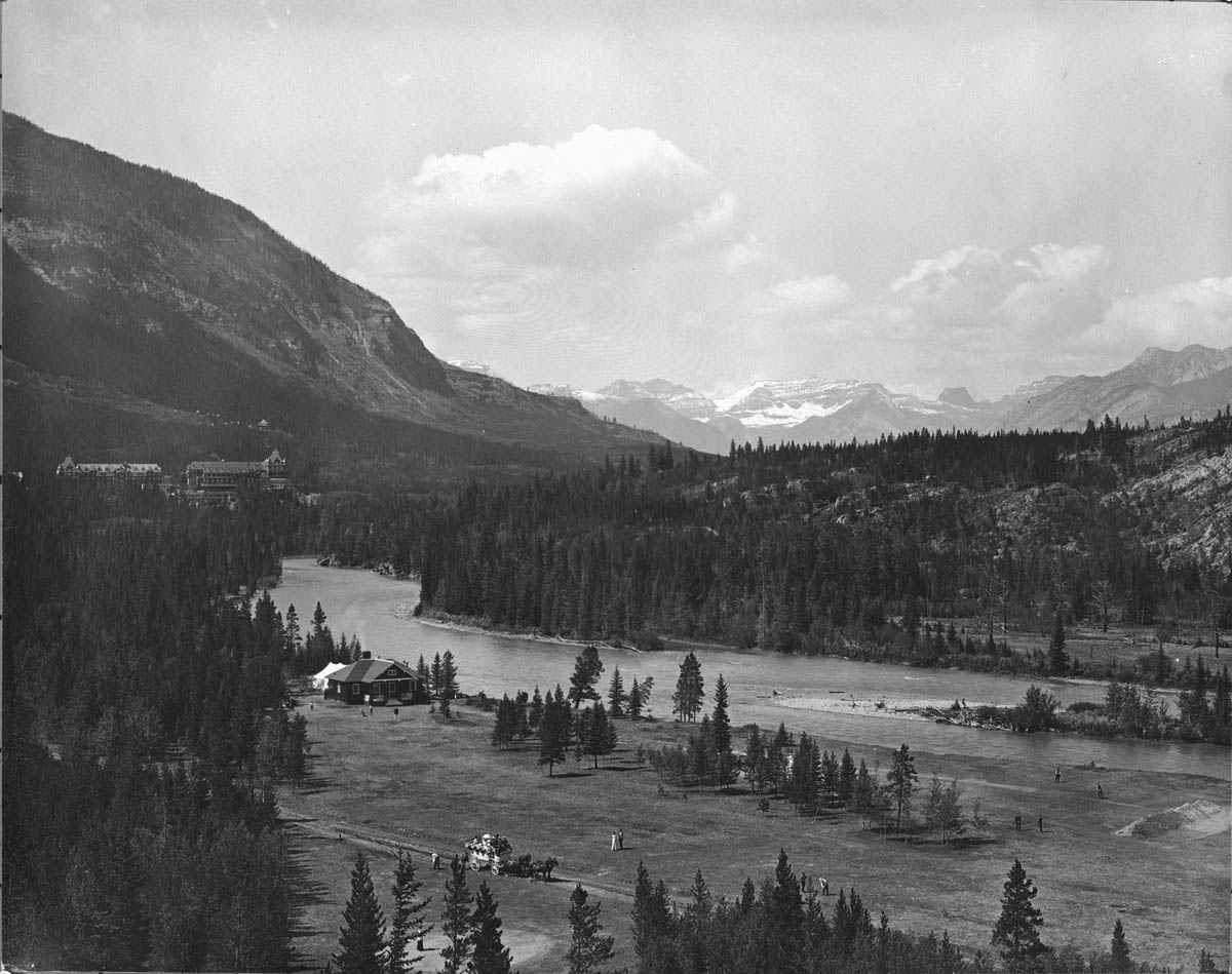 A man stading with Surfboard