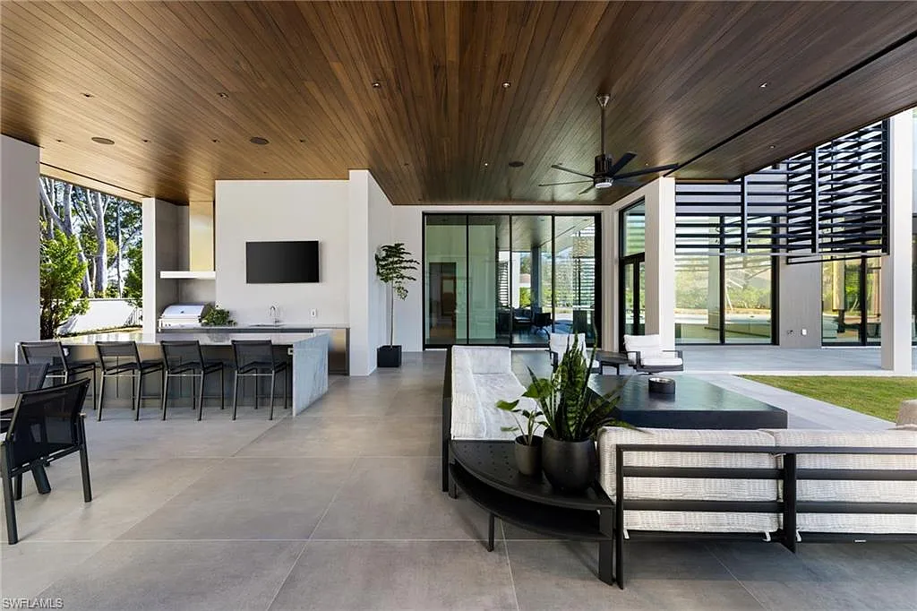 Luxury covered lanai with outdoor kitchen and lounge seating