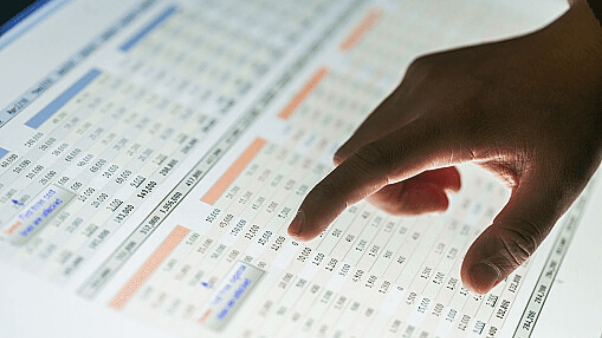 Finger pointing at financial spreadsheet data - 7 Ways to Apply Accounting Format in Excel in 10 Minutes