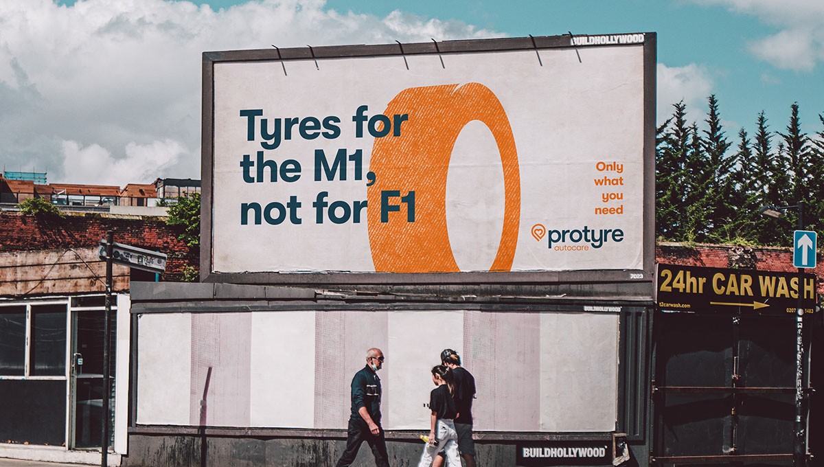 Billboard in a street in London, copy says 'Tyres for the M1, not for F1'
