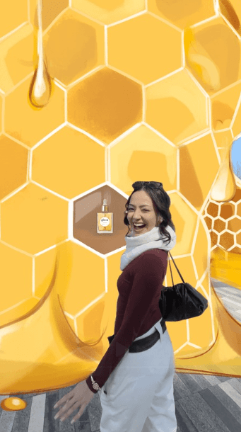 A final storyboard frame shows the woman smiling next to a glowing product bottle revealed inside a cell