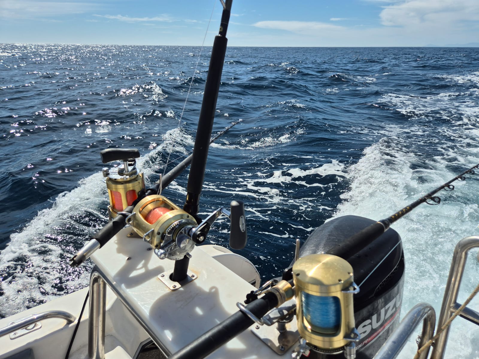 Fishing vessel with rods, reels, and tackle ready for charter.