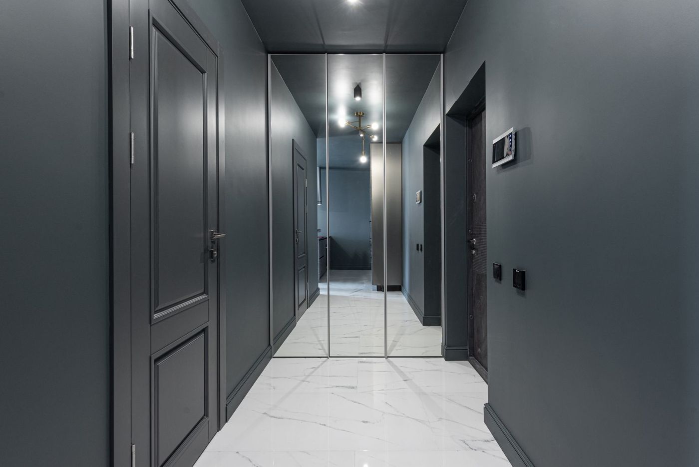Corridor with doors and mirrors in an apartment building