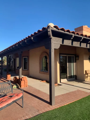 Covered patio with tile roof and brick pavers in Tucson
