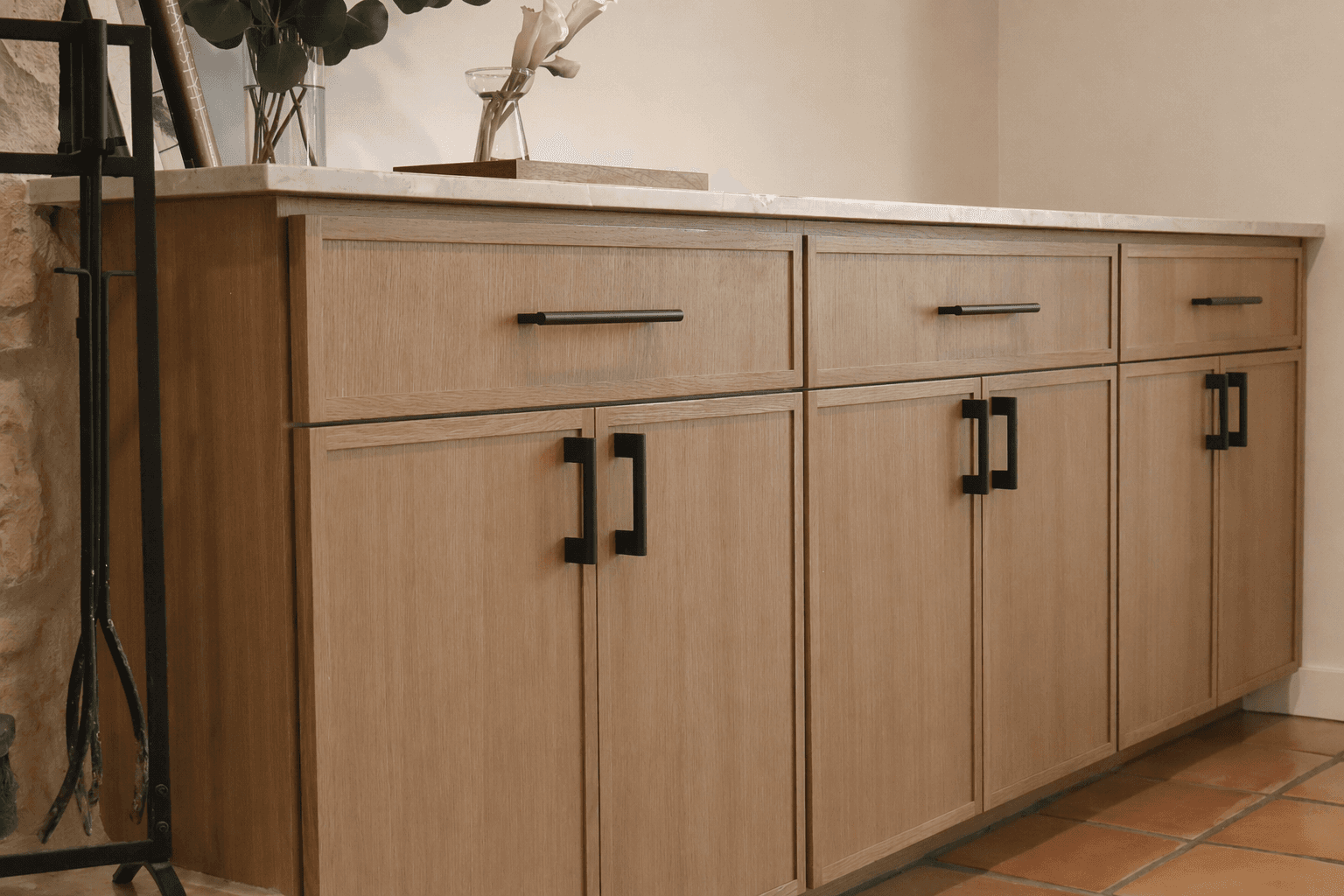 Custom white oak base cabinets with matte black square hardware and quartz countertop by QW Kitchen Bath Austin
