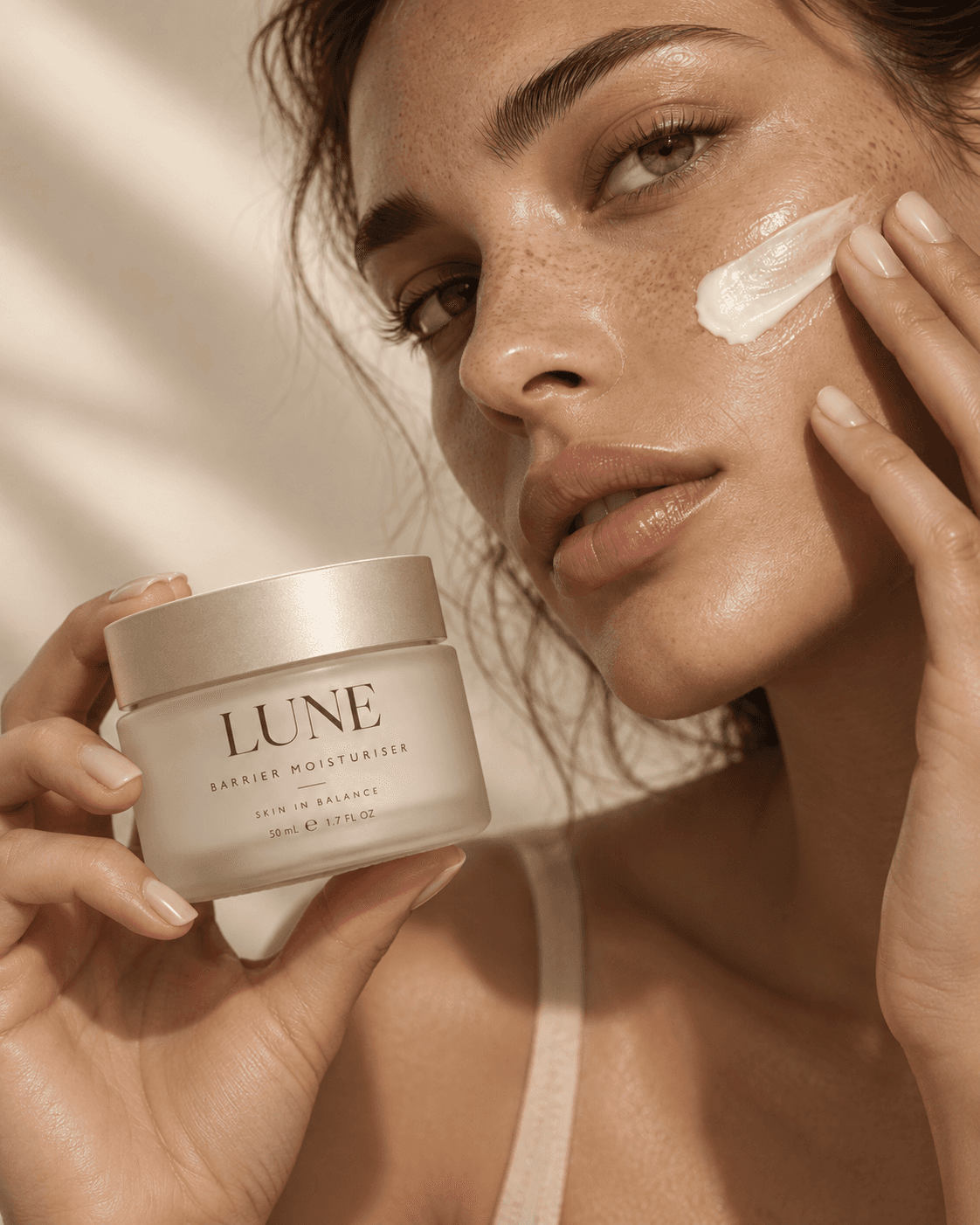 LUNE Recovery Cream held beside a model