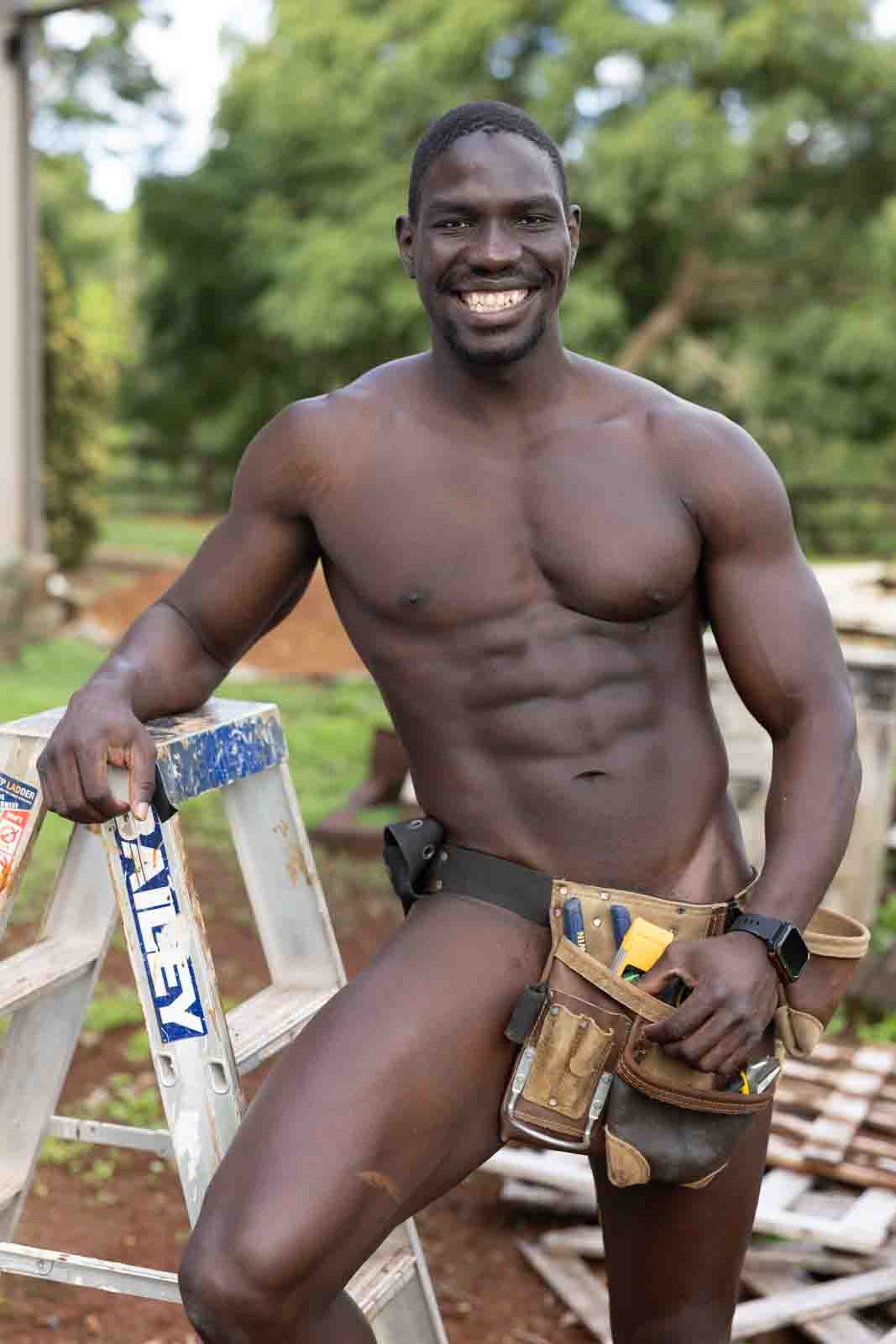 Naked tradesman wearing tool belt
