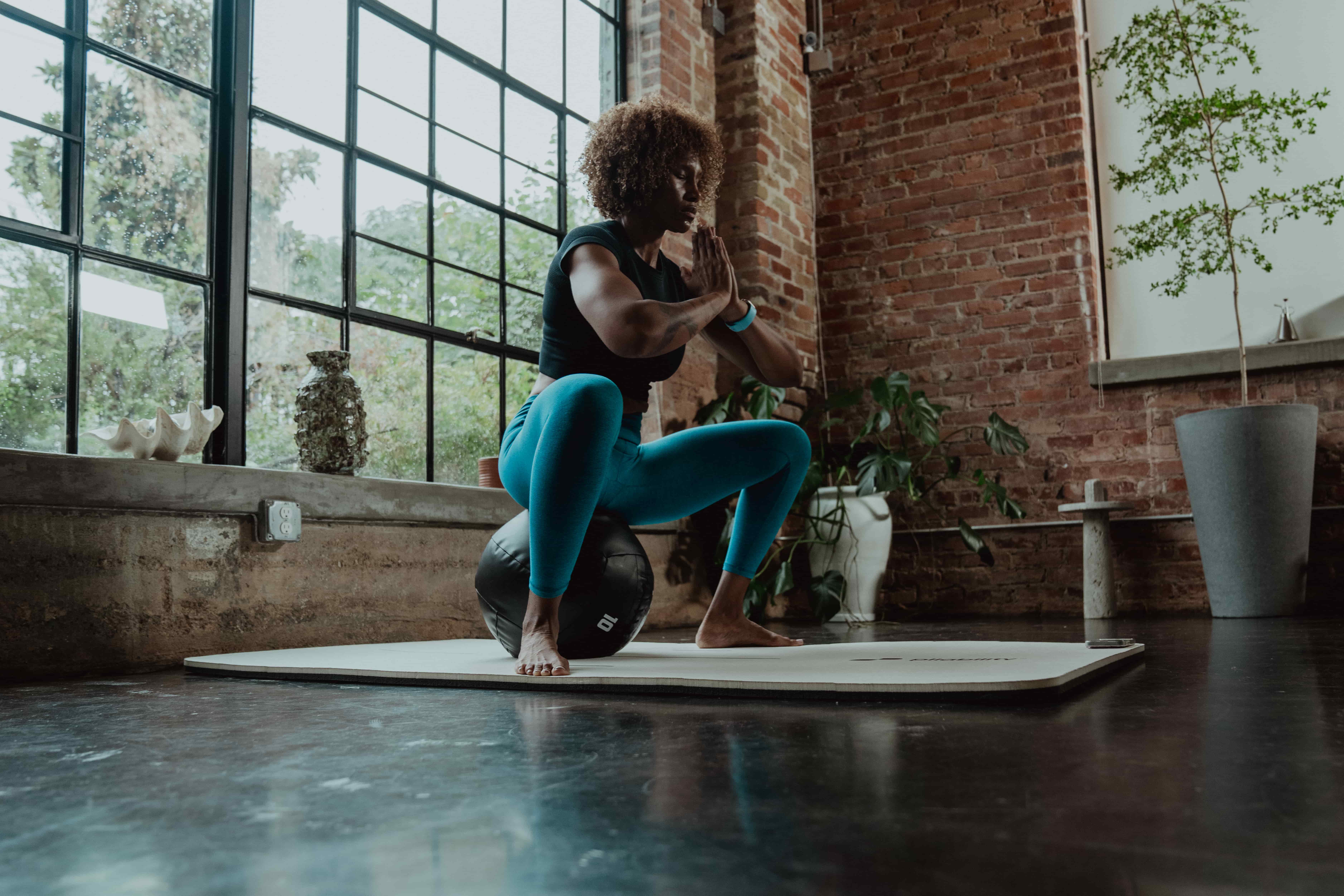 woman sitting on a ball - Glute Stretches