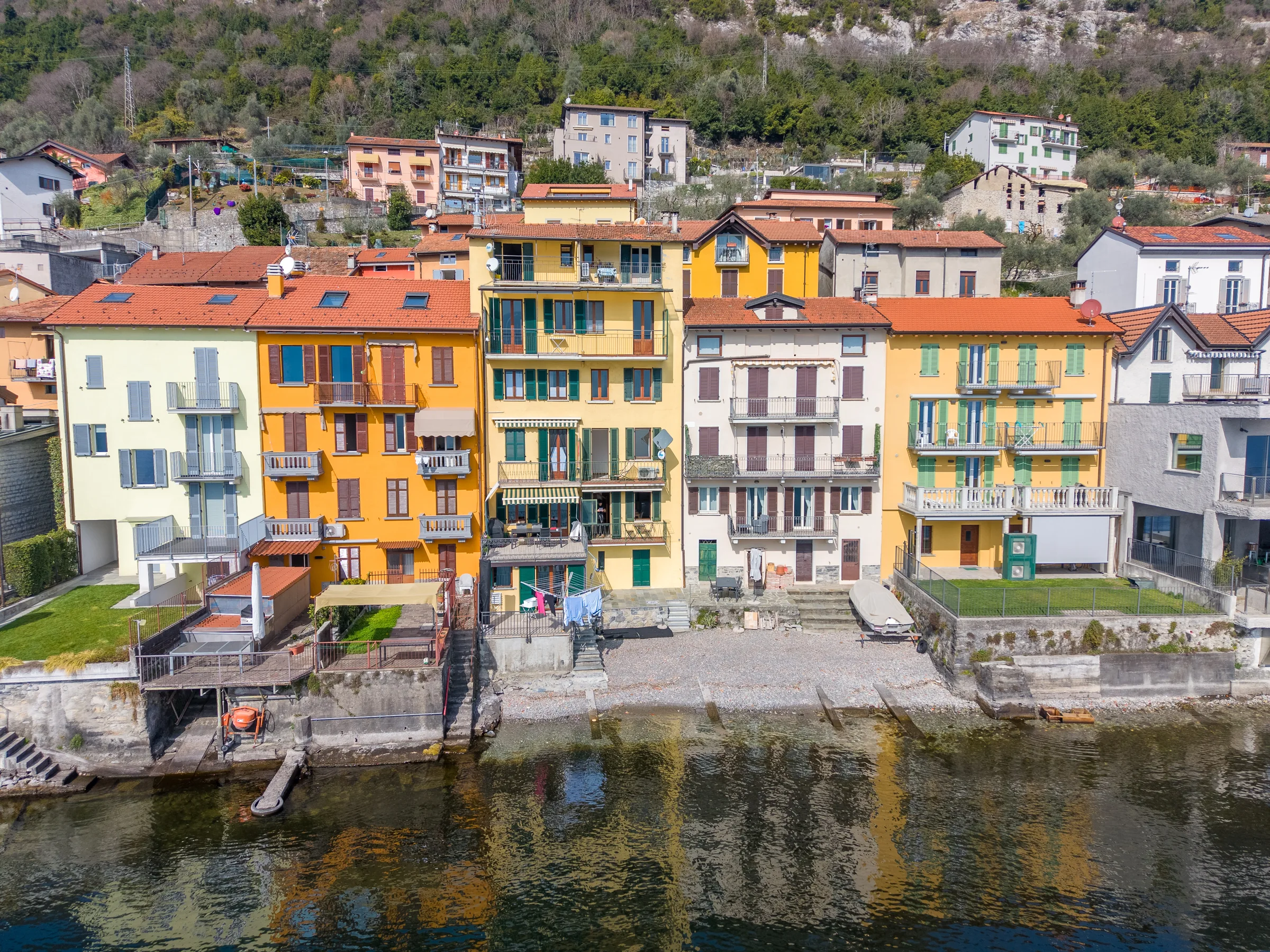 Colourful facades along the lakeshore — Lake Como, Italy. Photography by Yunes Calore.