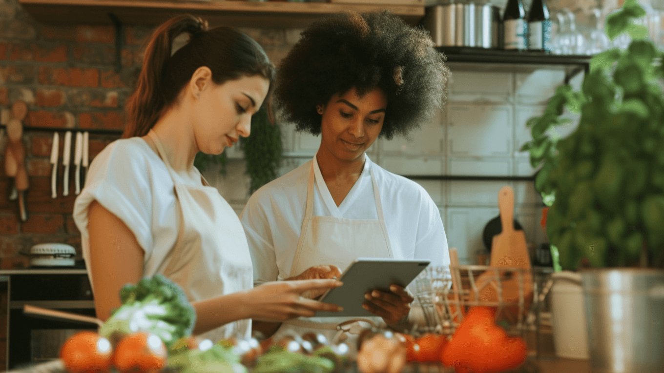 Two friends creating a meal plan in the kitchen.