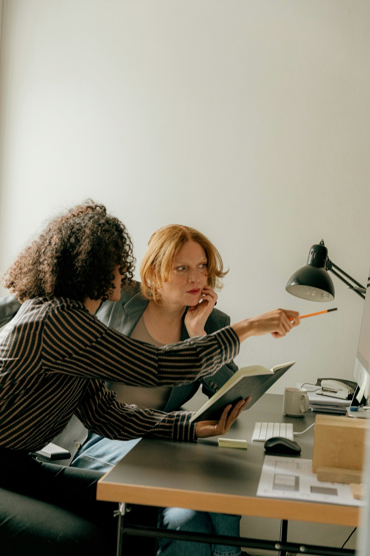 Two women engaged in a project discussion.