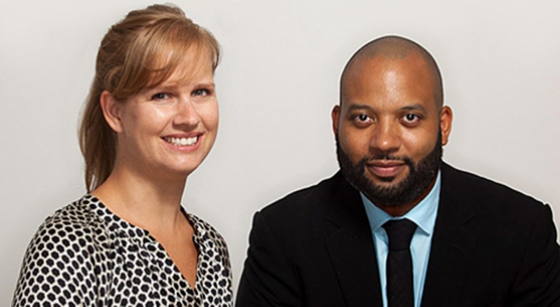 A photo of a man wearing a suit and a woman wearing a shirt.