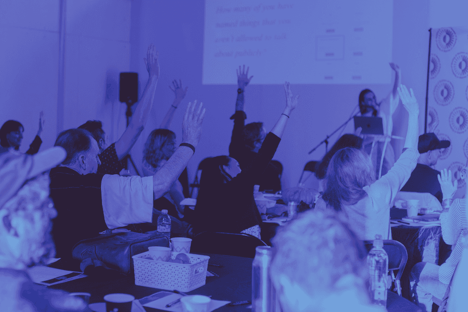 People sitting and listening to a speaker