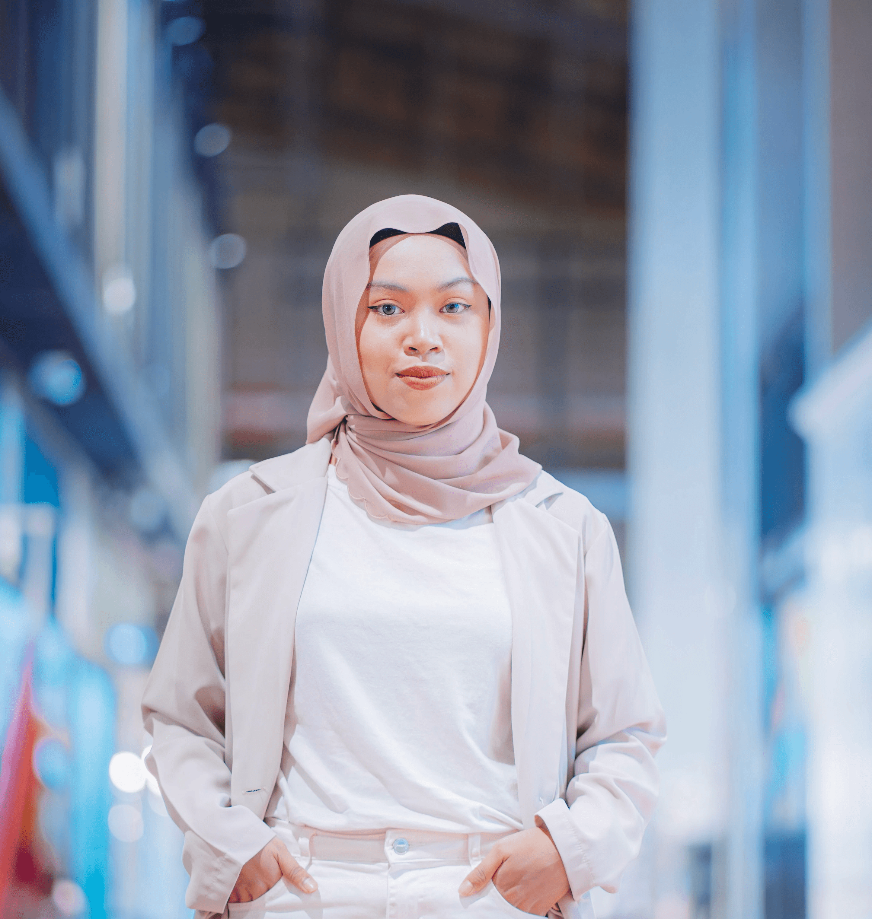 a woman in a hijab walking down a hallway