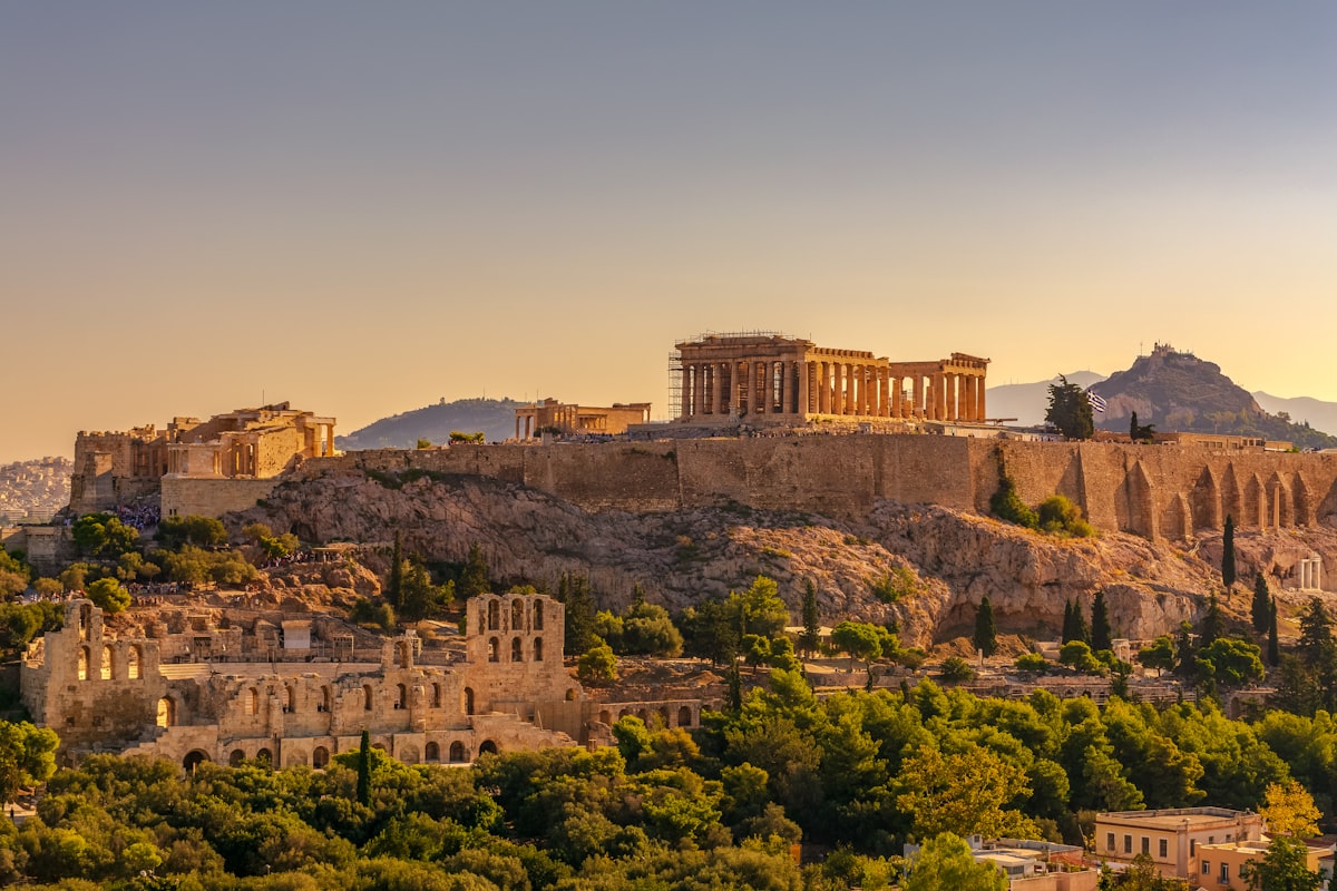 Parthenon and Erechtheion on the Acropolis bathed in warm golden hour light over Athens