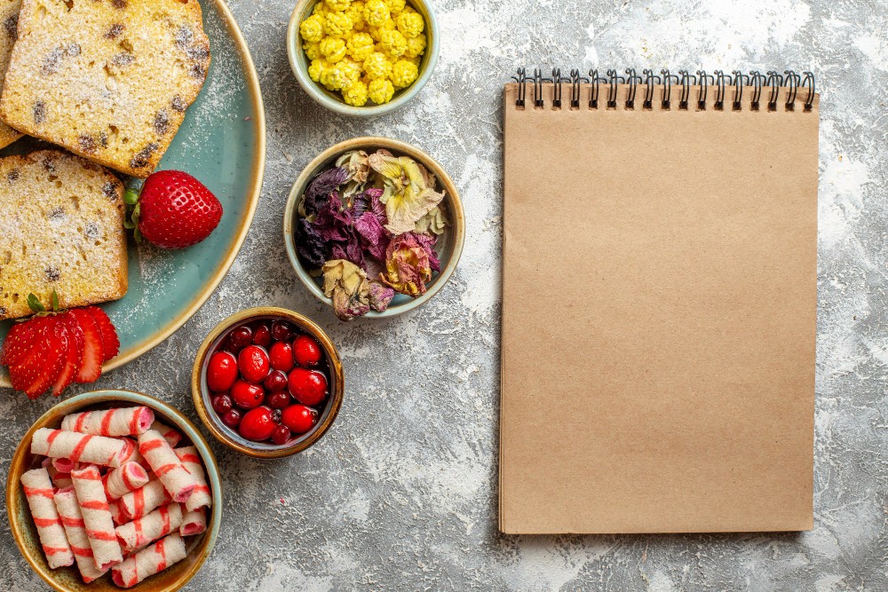 Top view delicious cake slices with fruits on light floor sweet pie fruit cake