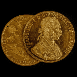 an image of two antique coins against a black background