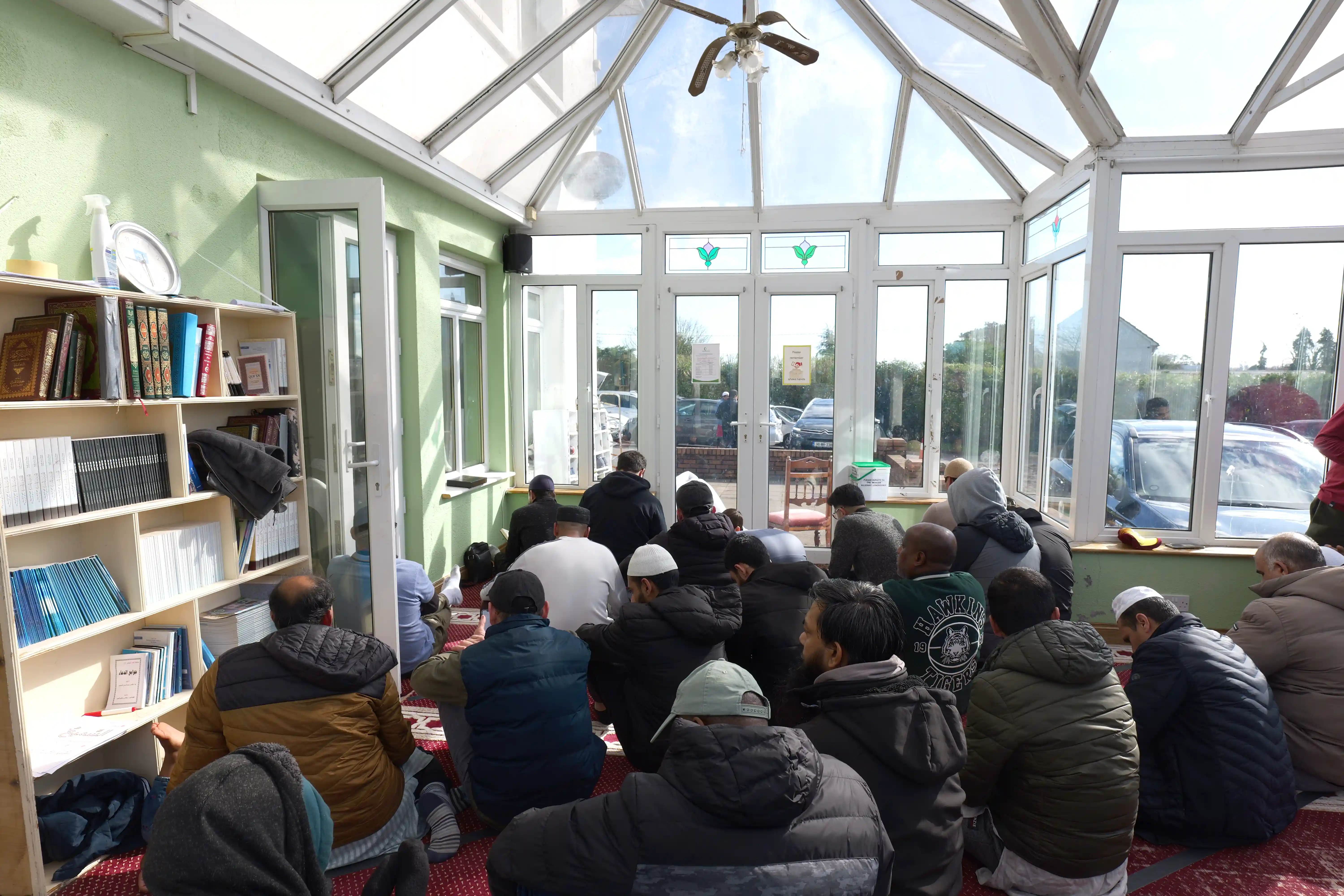 five children smiling while doing peace hand sign