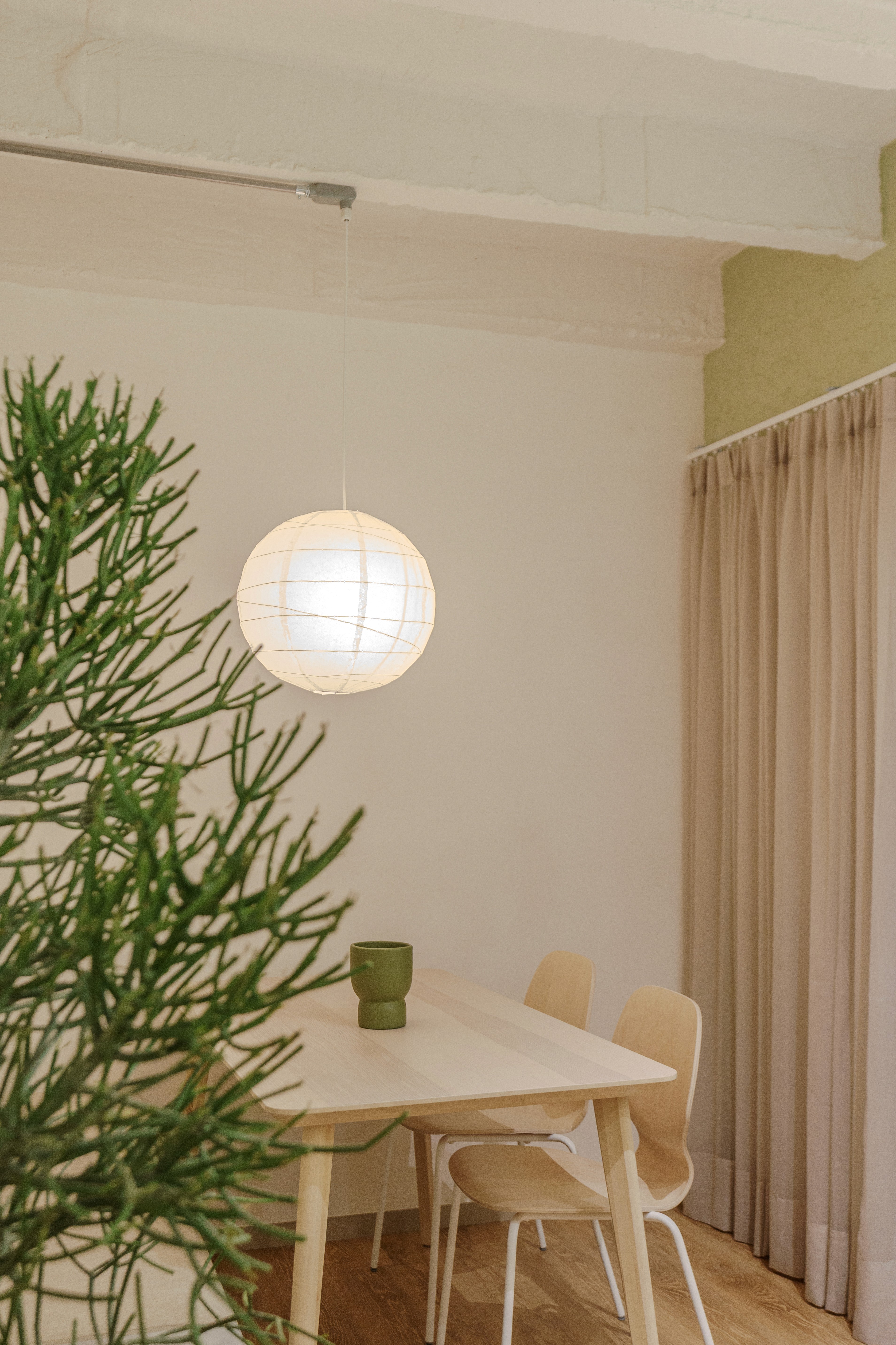 Double-height interior with flowing sculptural forms and warm raking light
