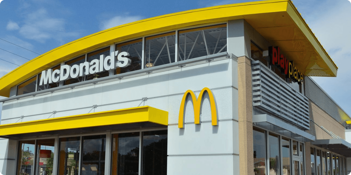A photo of a McDonald's Restaurant set against a clear blue sky.