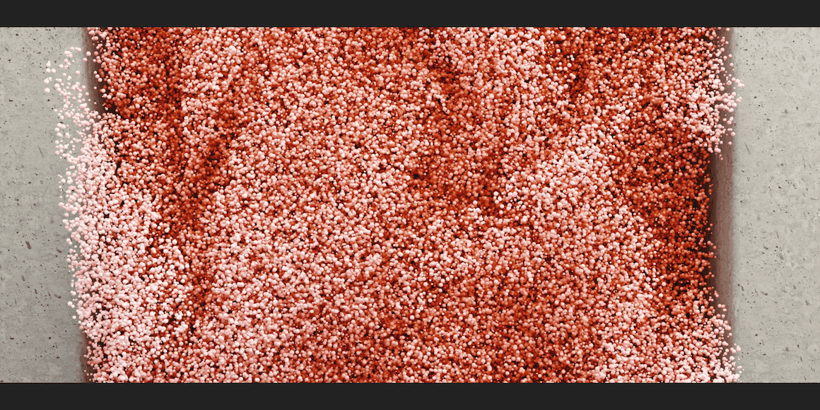 Close-up texture of red and rust-colored speckled material