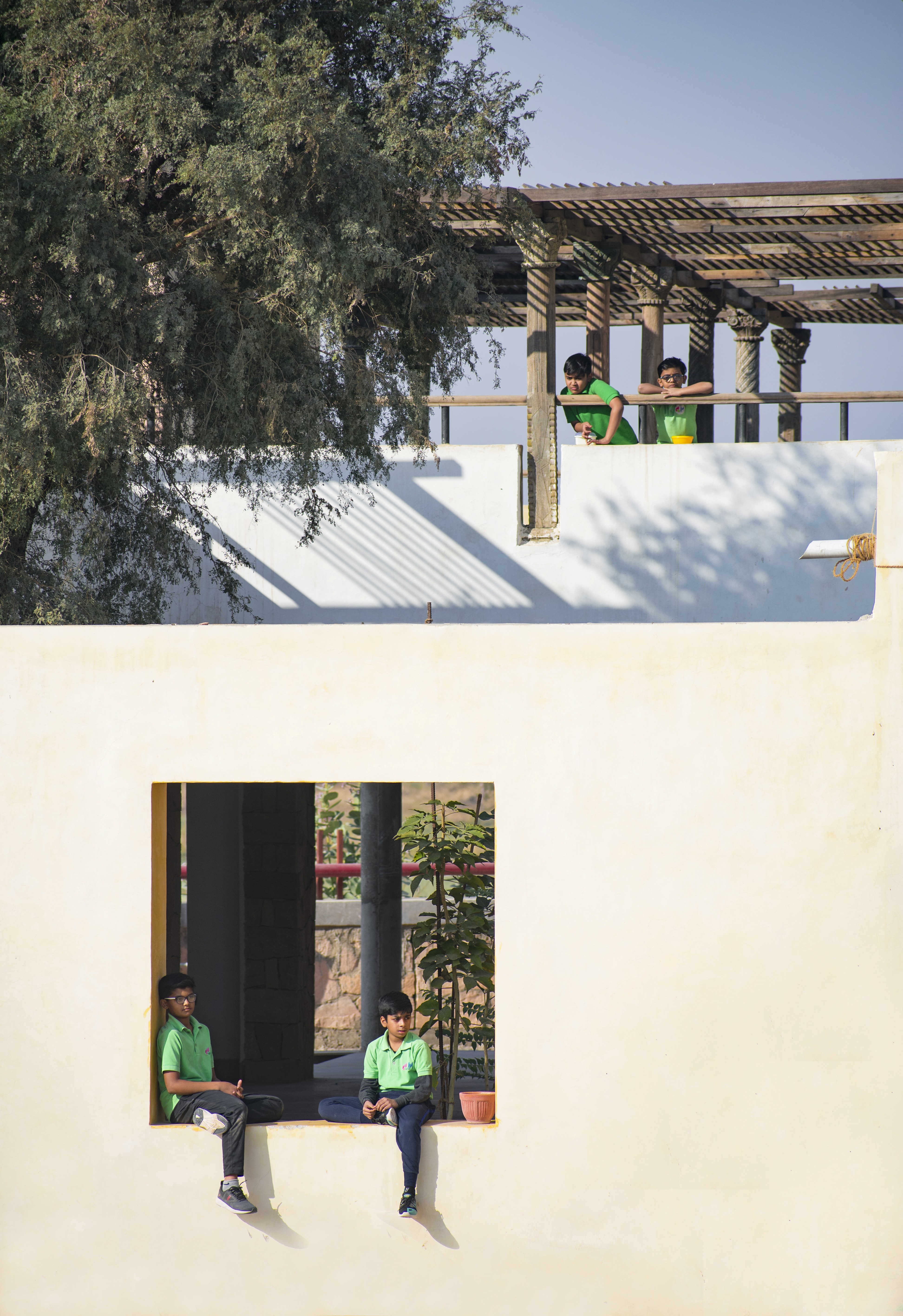 A teacher is explaining a topic to the class, speaking with gestures to emphasize points