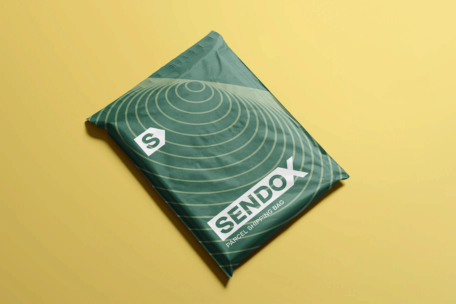 Shipping bag mockup shown in green with a white circular line pattern.