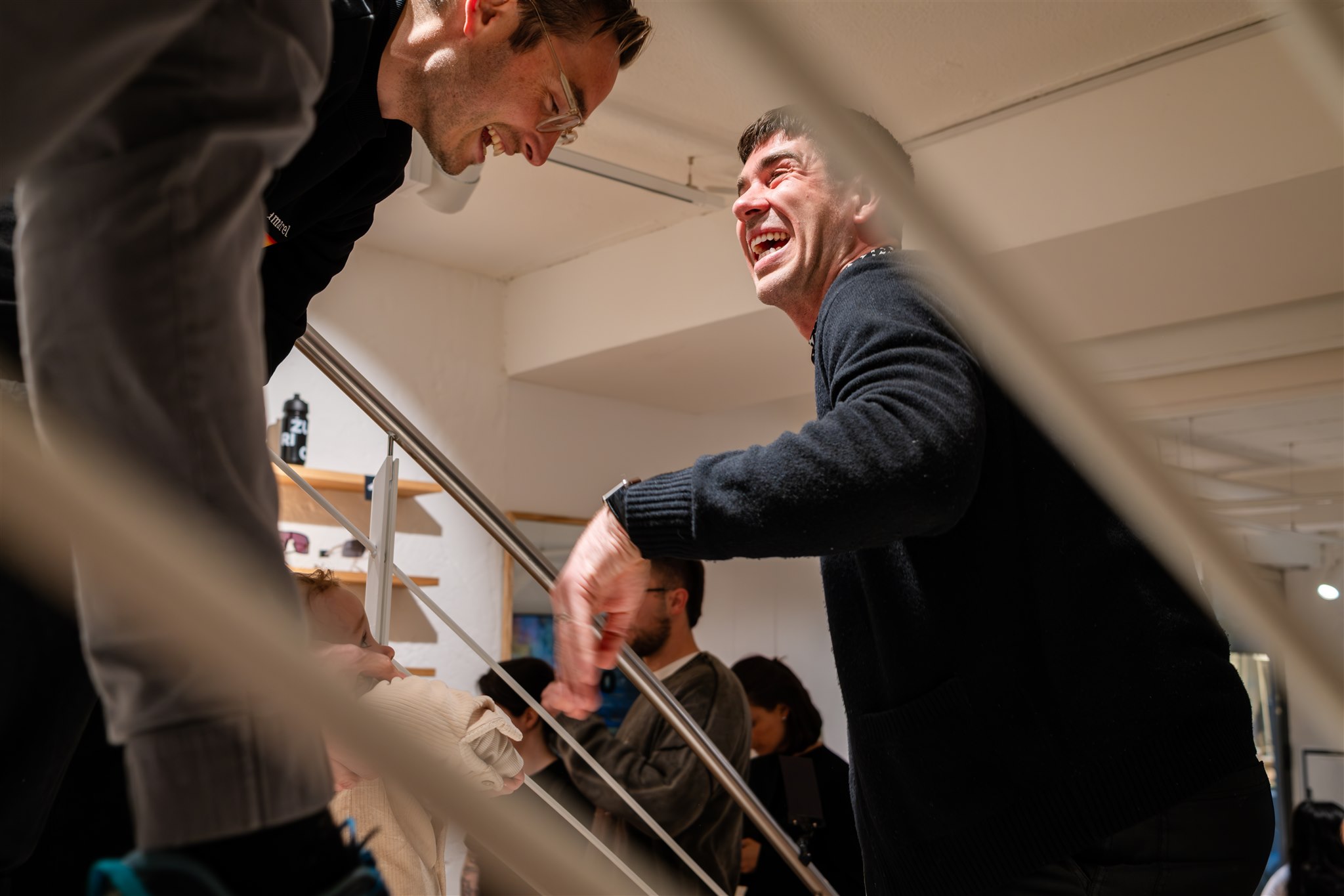 Guests interacting and laughing at networking event in Zurich