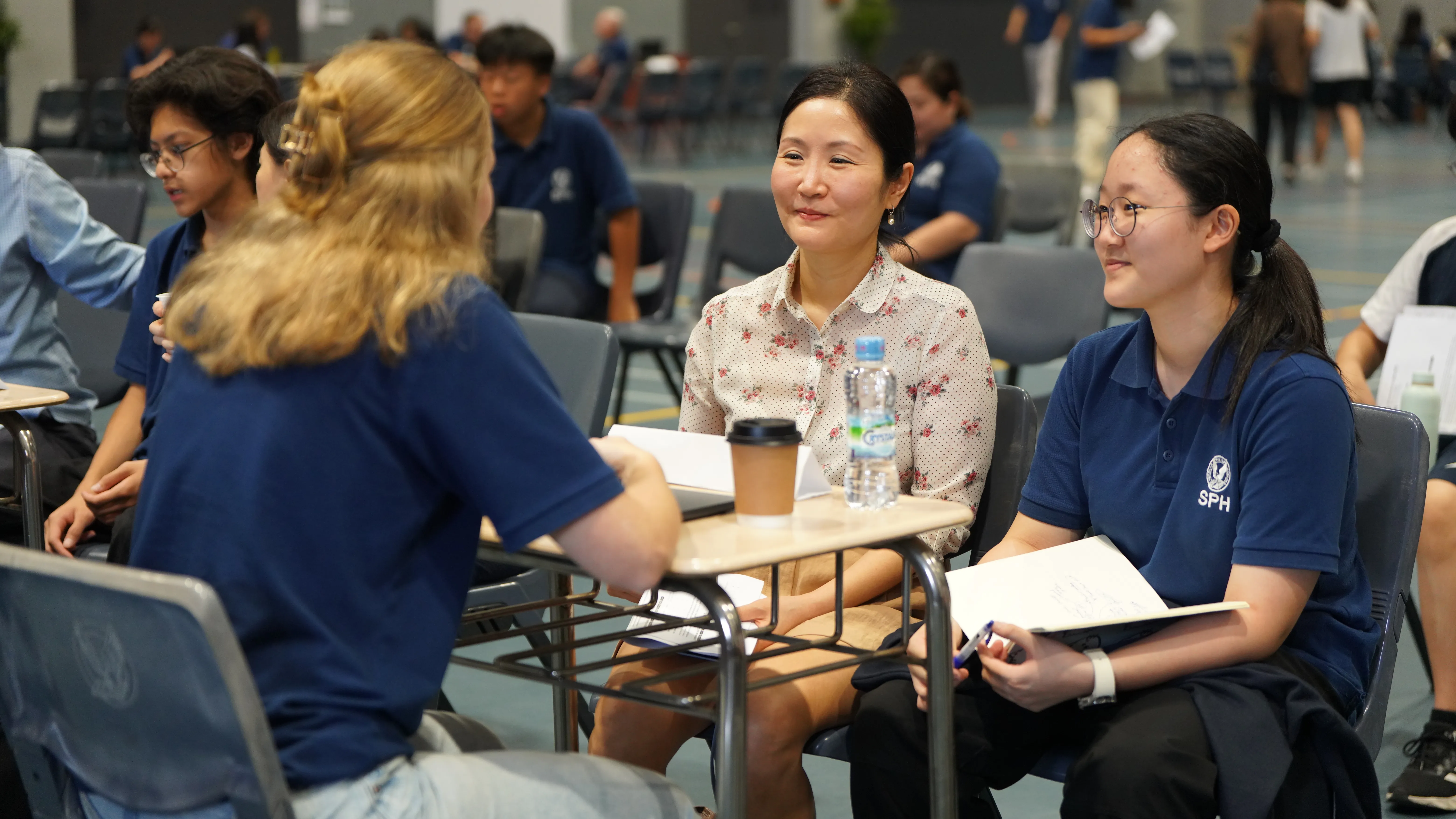 woman carrying white and green textbook