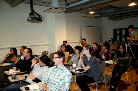 A photo of a group of students in a classroom sitting and following the lecture.