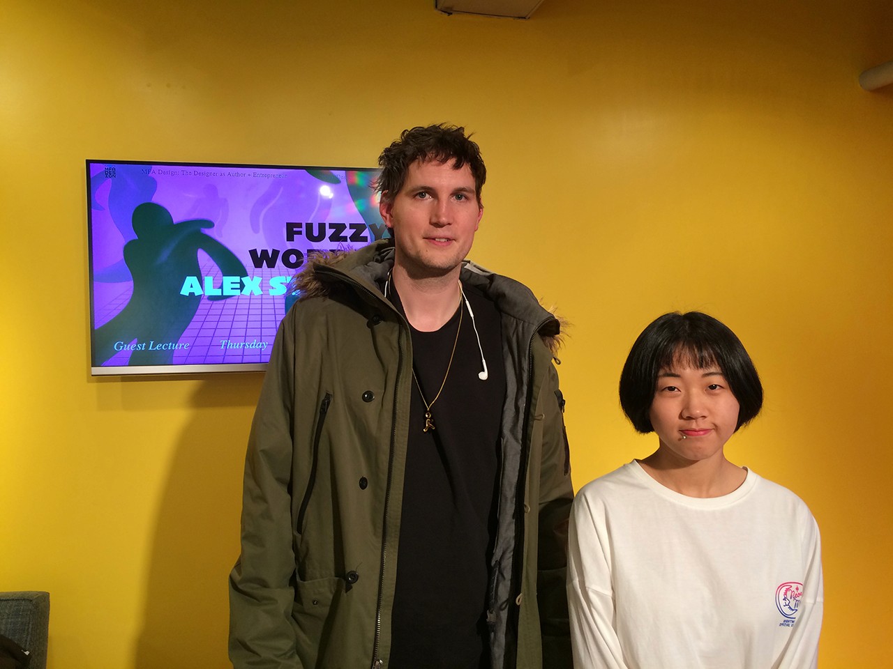 A photo of a man and a woman standing in an exhibition room.