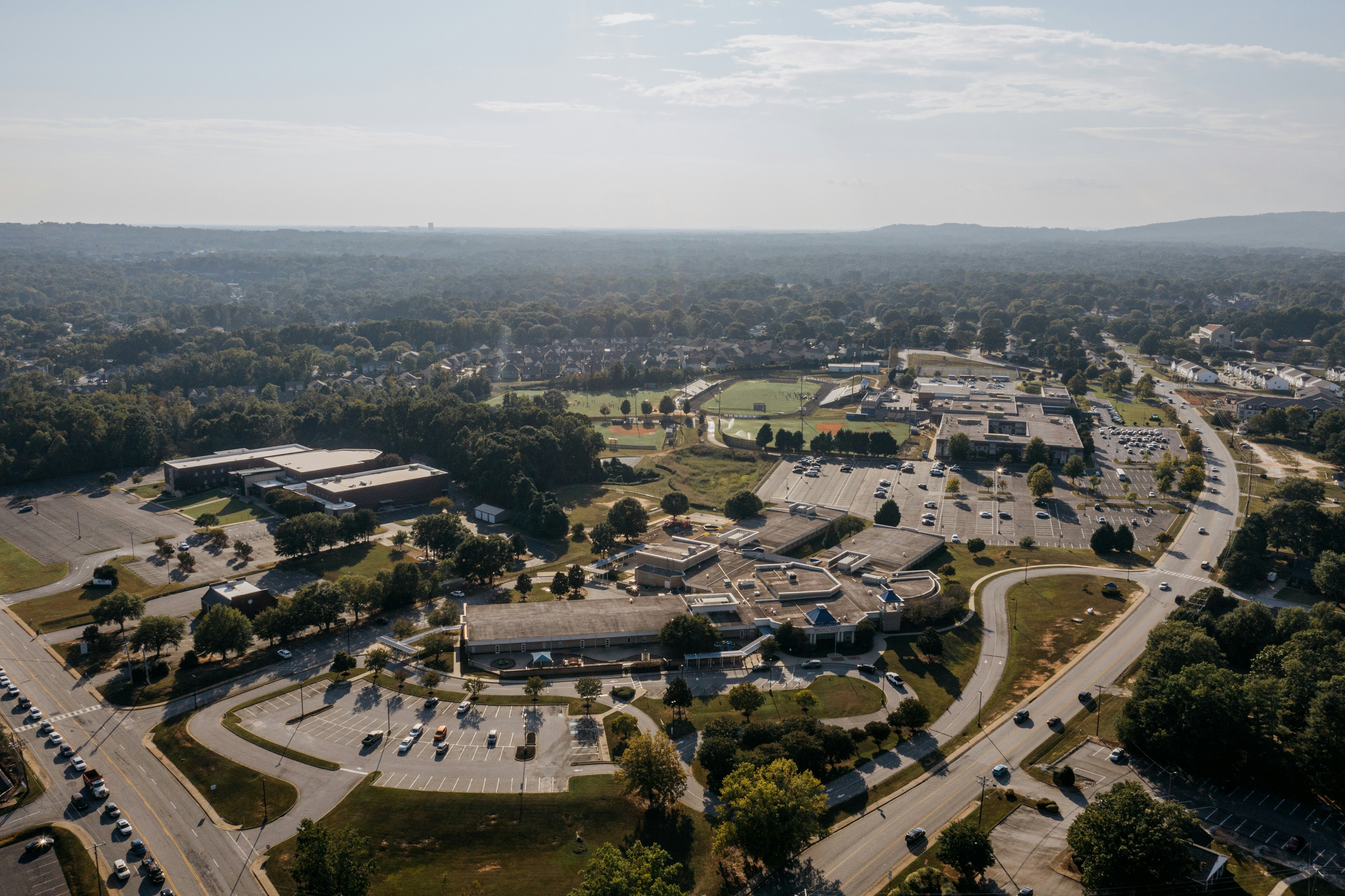 Aerial view of a suburban town with roads and buildings.