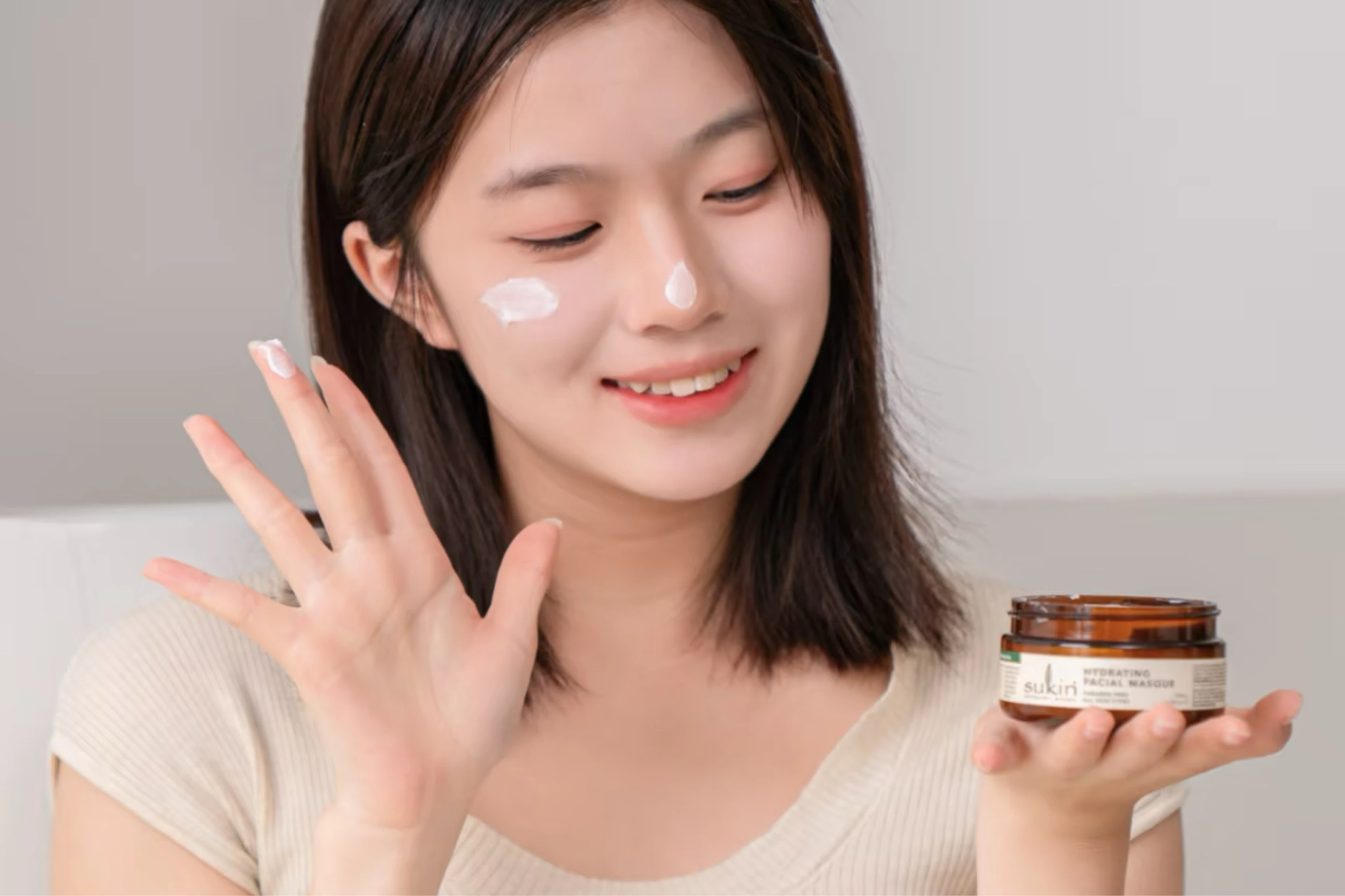 Chinese woman applies Sukin skincare