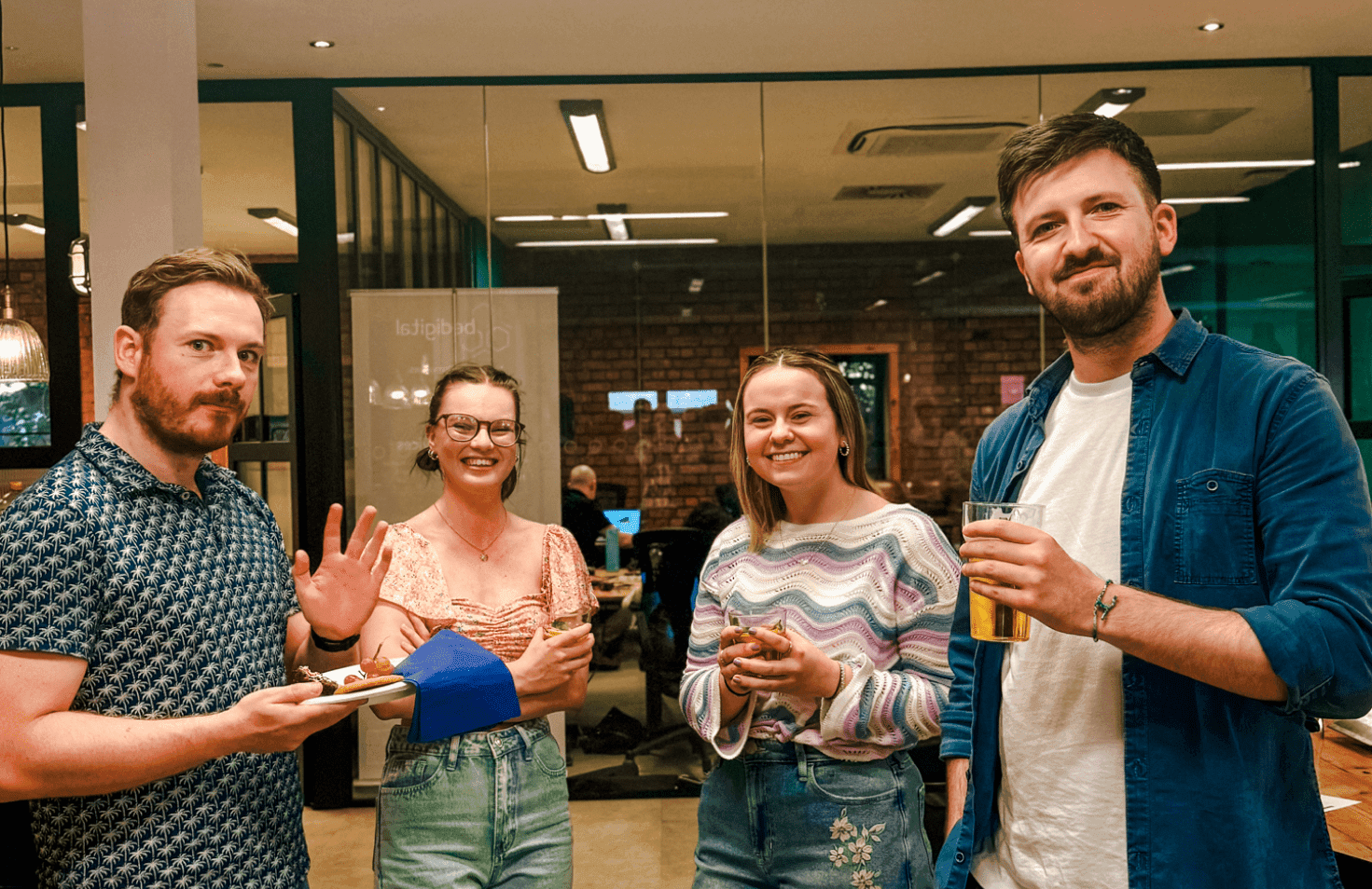 People talking and smiling in a cozy indoor setting.