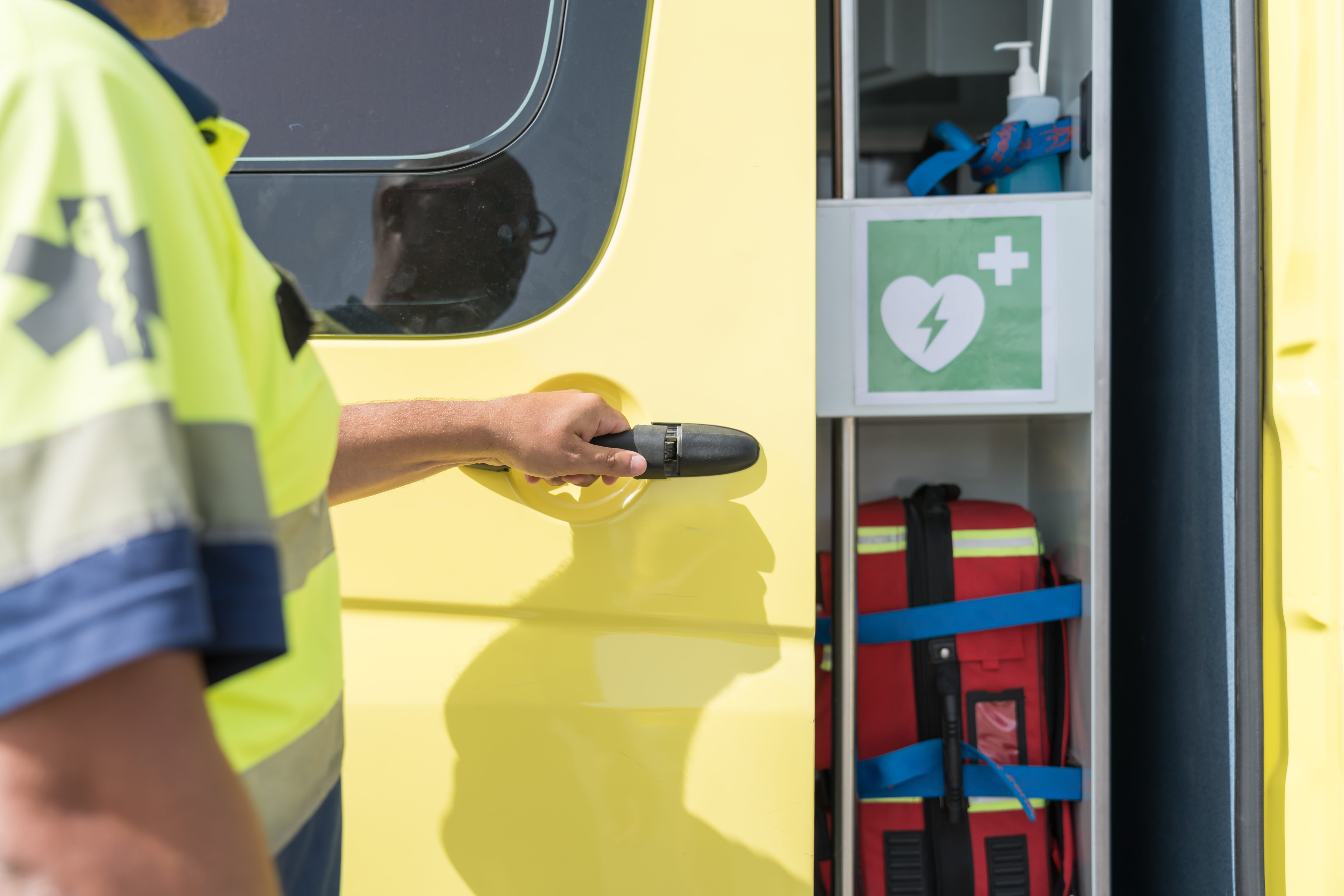 Paramedic Opening Ambulance Door for Emergency