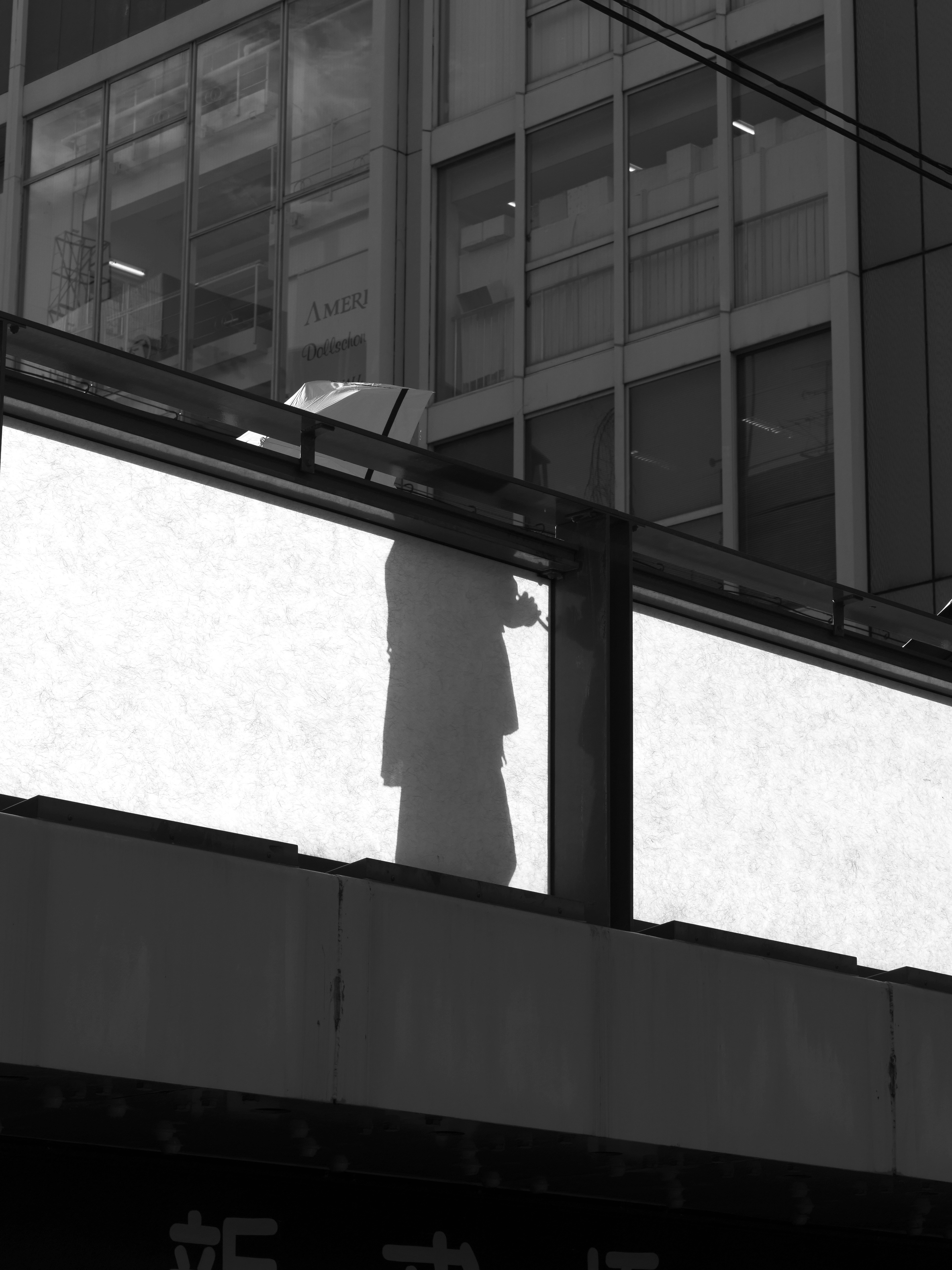 Silhouette of a person reflected on a building window