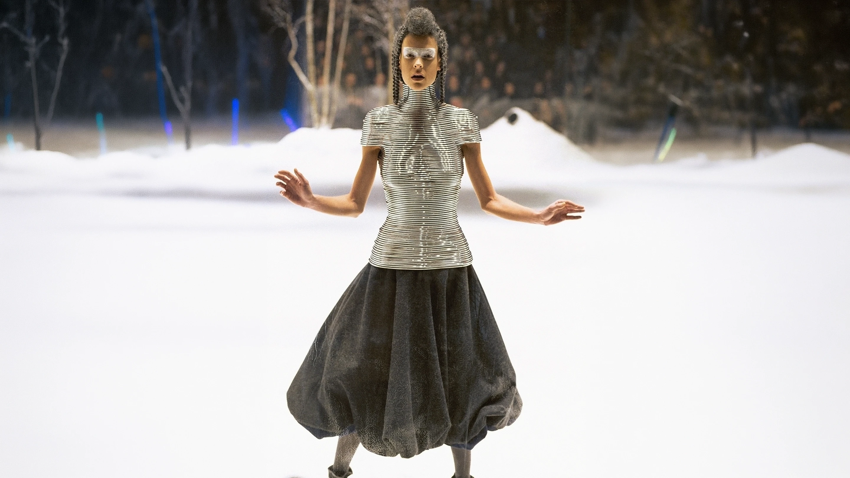 Shaun Leane for Alexander McQueen Coiled Corset made of contoured aluminium rings, worn by a model in a winter snow runway setting