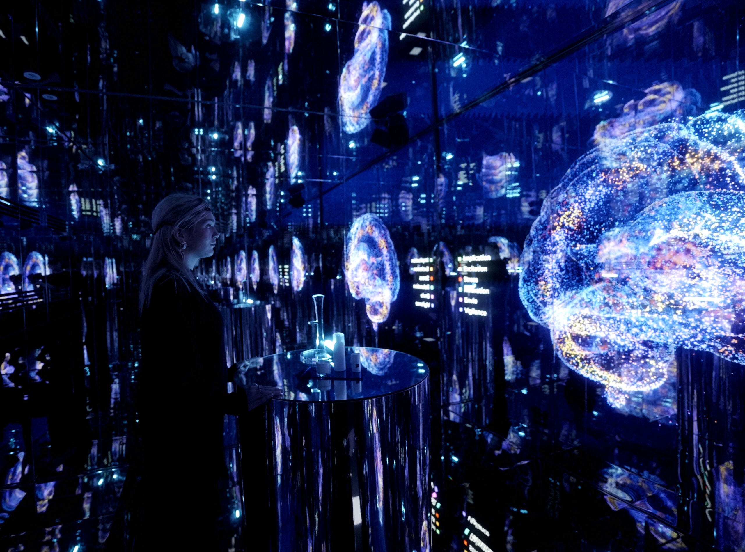 Photo of a visitor inside Anjac's HQ new showroom infinity room, where emotions are tracked via an EEG-powered and used to interact in real-time with generative visuals.