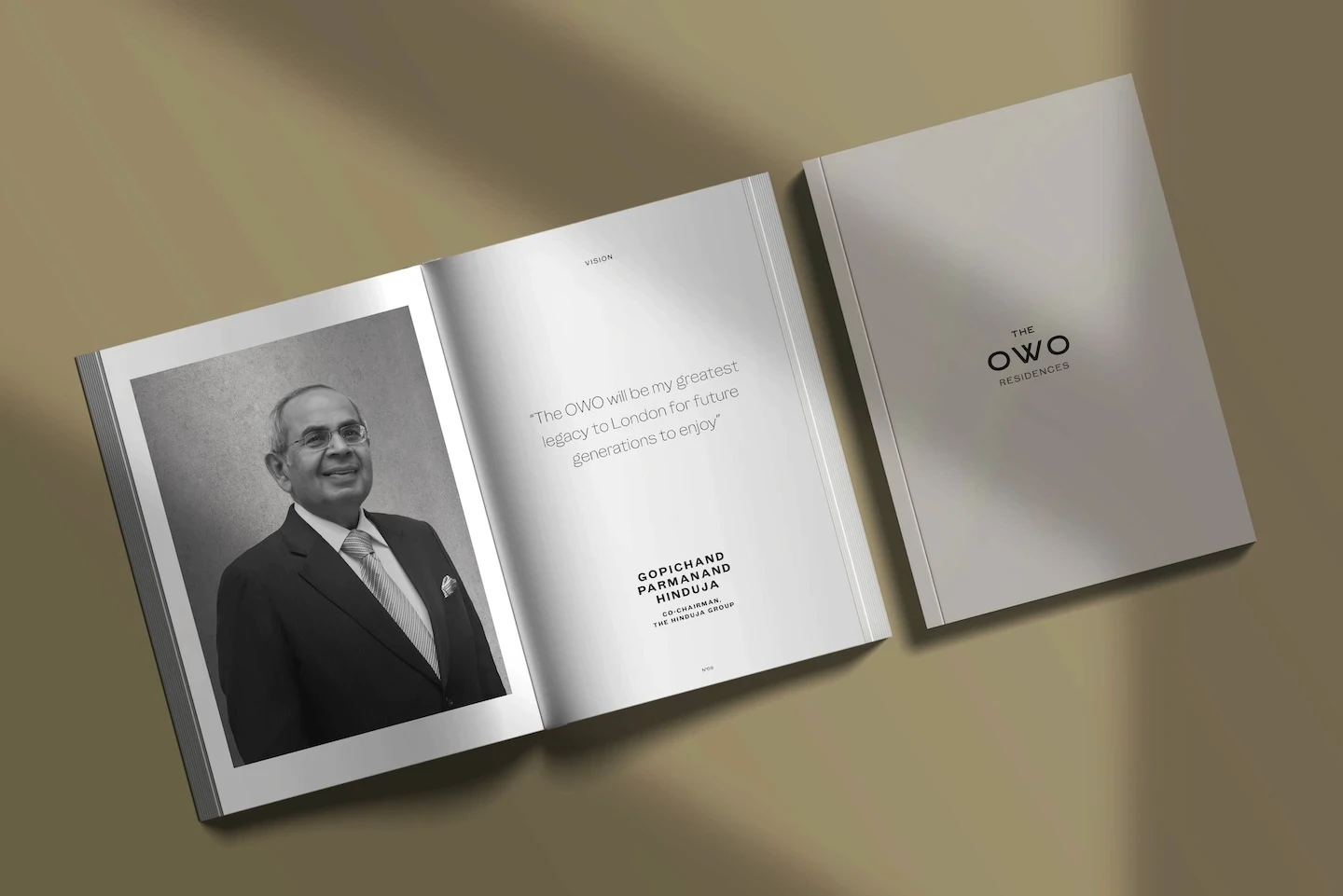 Open brochure showing a black-and-white portrait with a quote about The OWO legacy, next to a closed cover reading “The OWO Residences”.