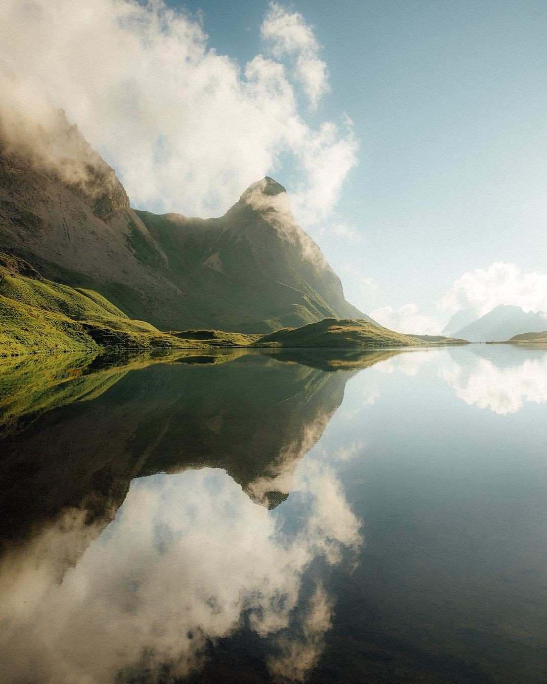 a woman wearing a black coat and a white scarf